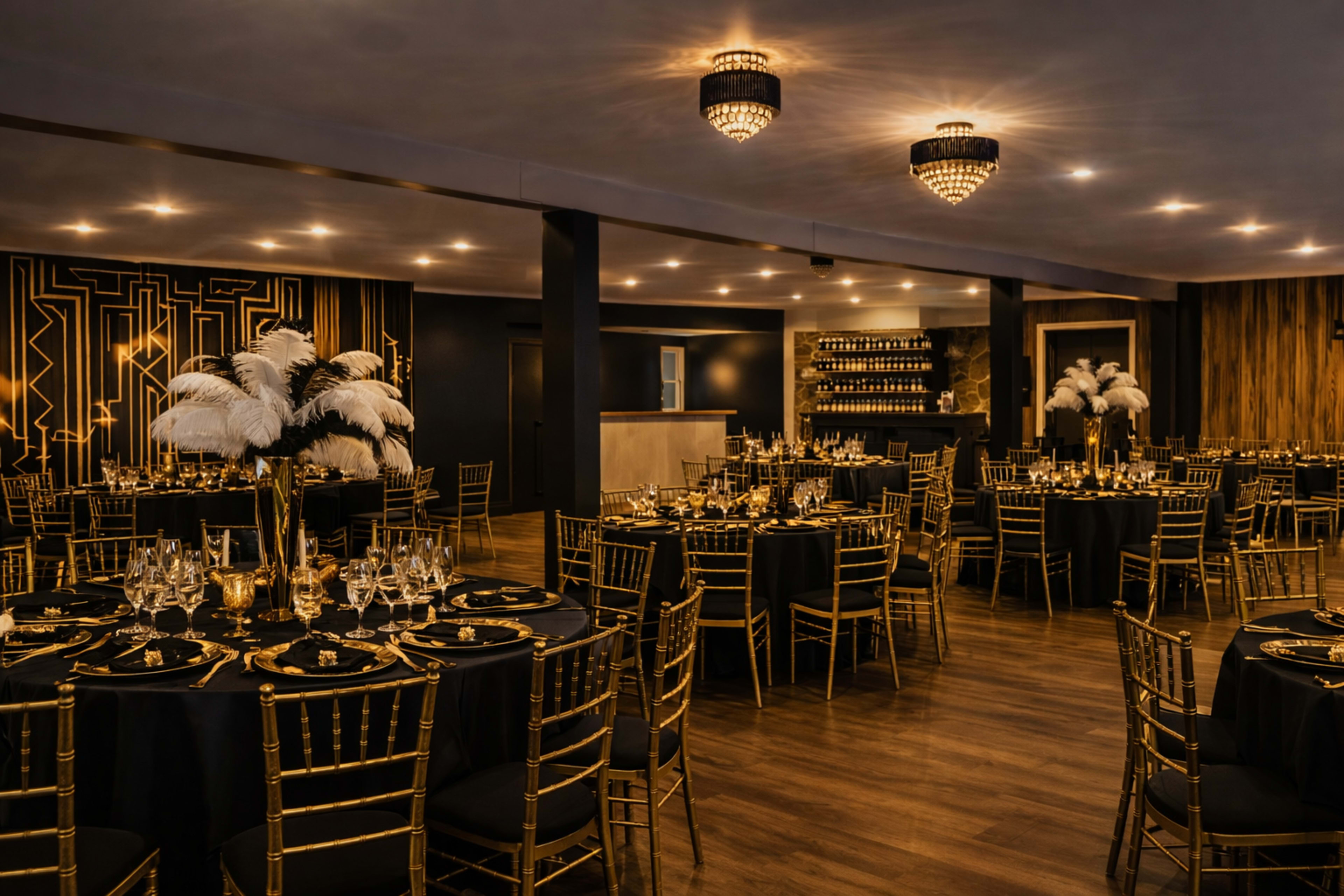 The image shows a sophisticated dining area with elegantly set tables featuring black linens, gold accents, and decorative centerpieces, illuminated by chandeliers overhead.