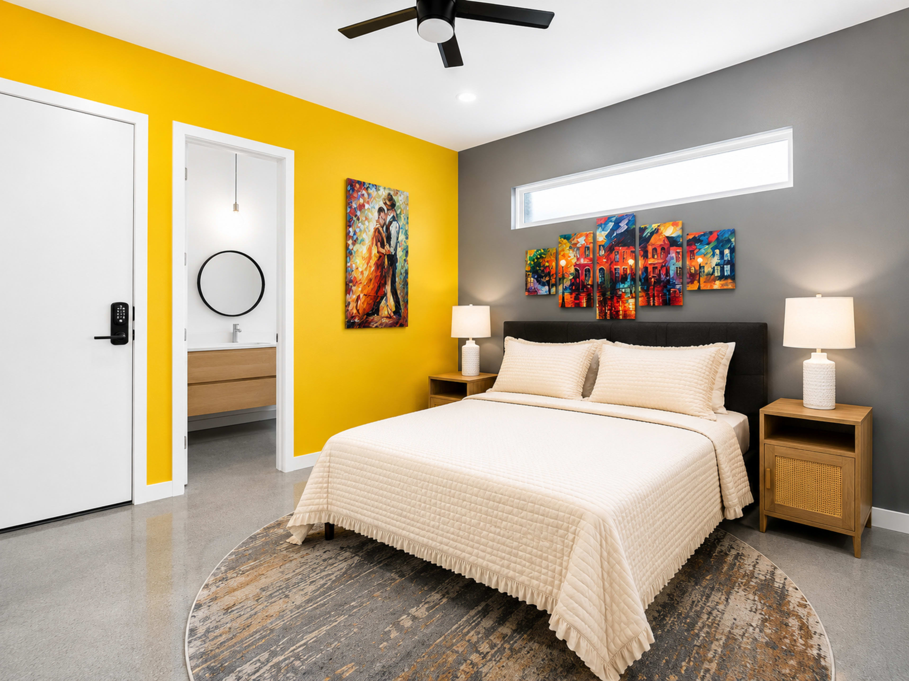 The room features a queen-sized bed with a neutral bedspread, two bedside tables with lamps, and vibrant artwork on the walls, alongside a yellow and gray color scheme.