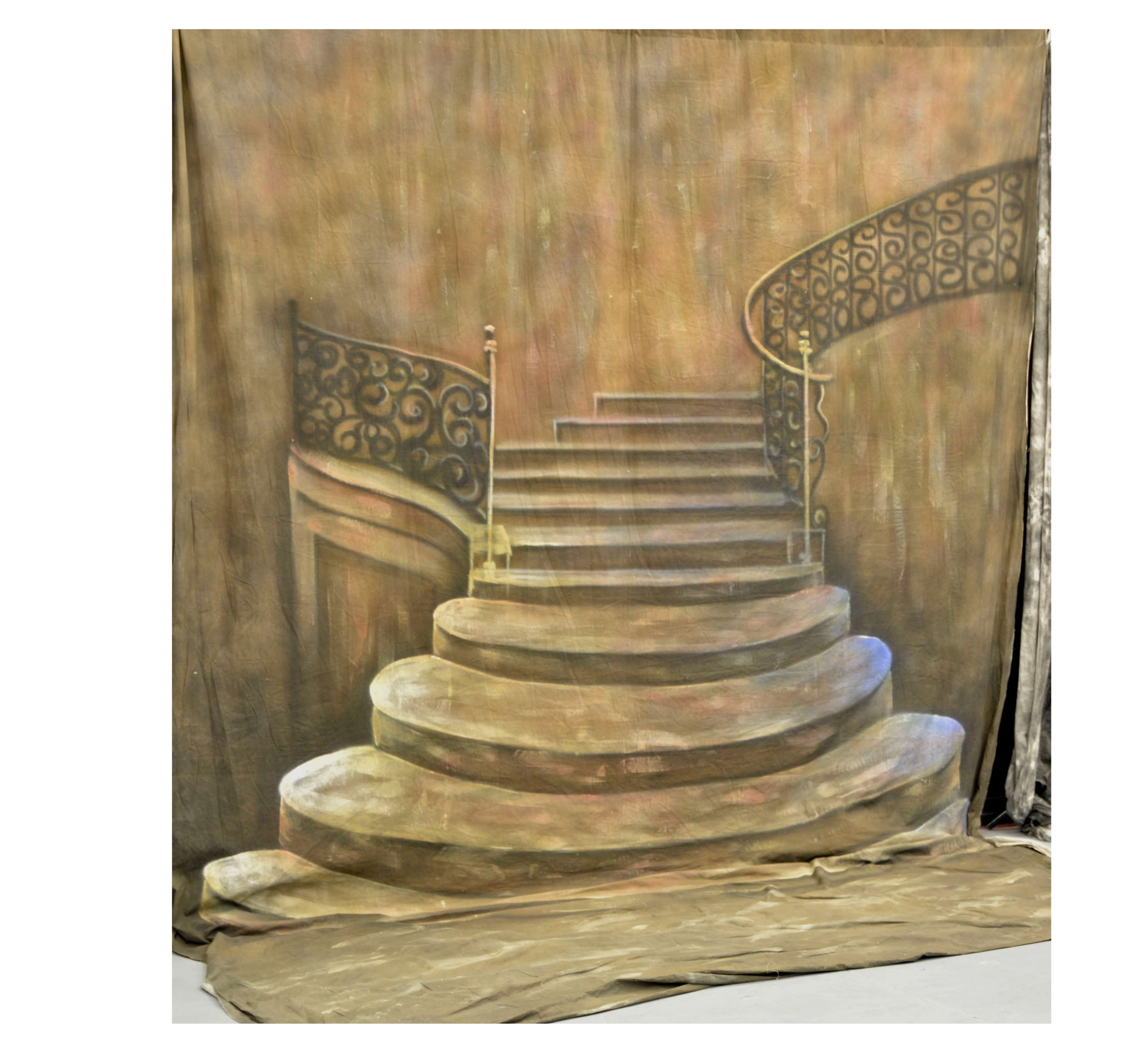 A painted backdrop of a spiraling staircase with a decorative iron railing.