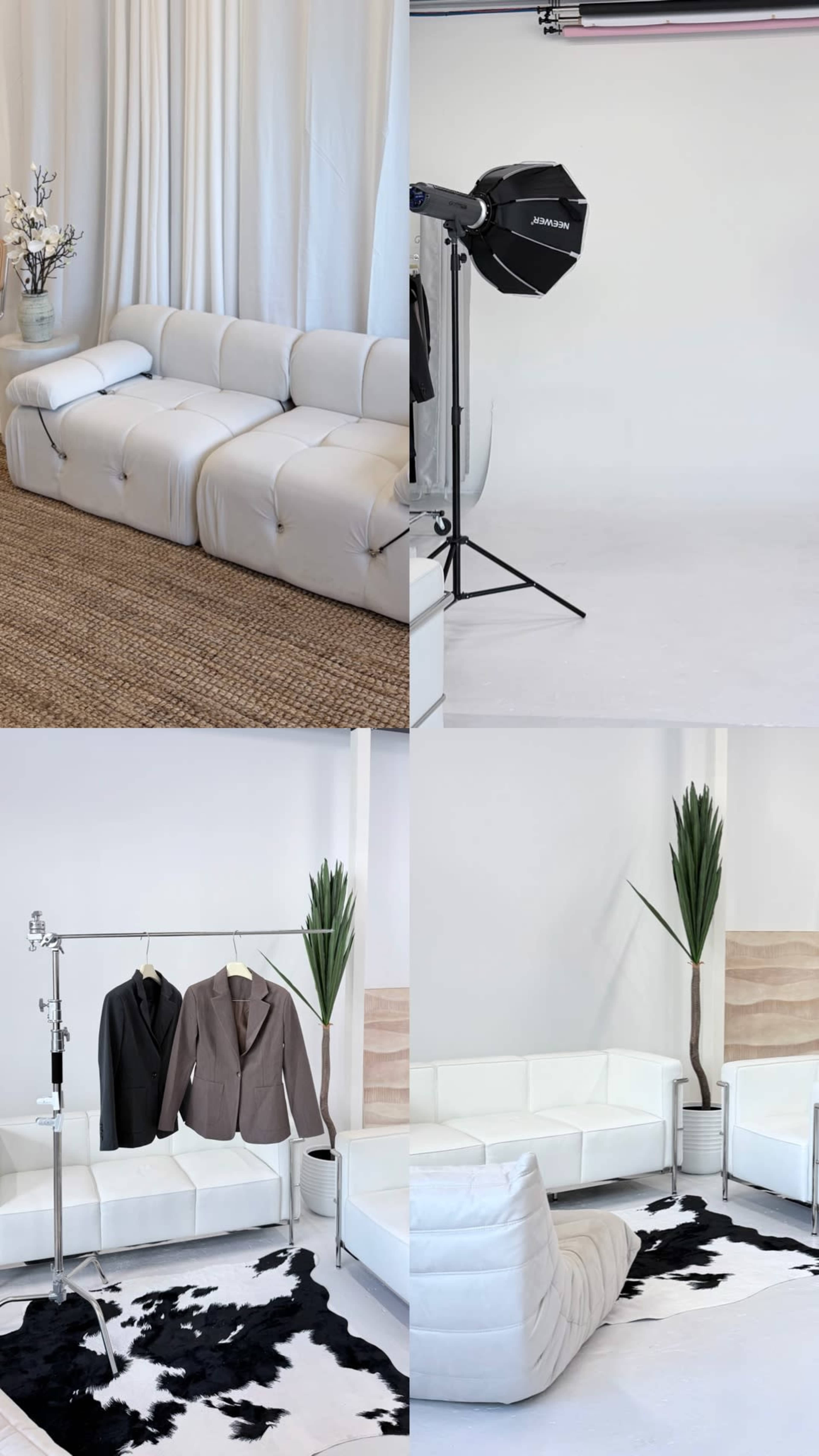 The image displays a bright, minimalist studio featuring white furniture, a clothing rack with suits, and a backdrop intended for photography.