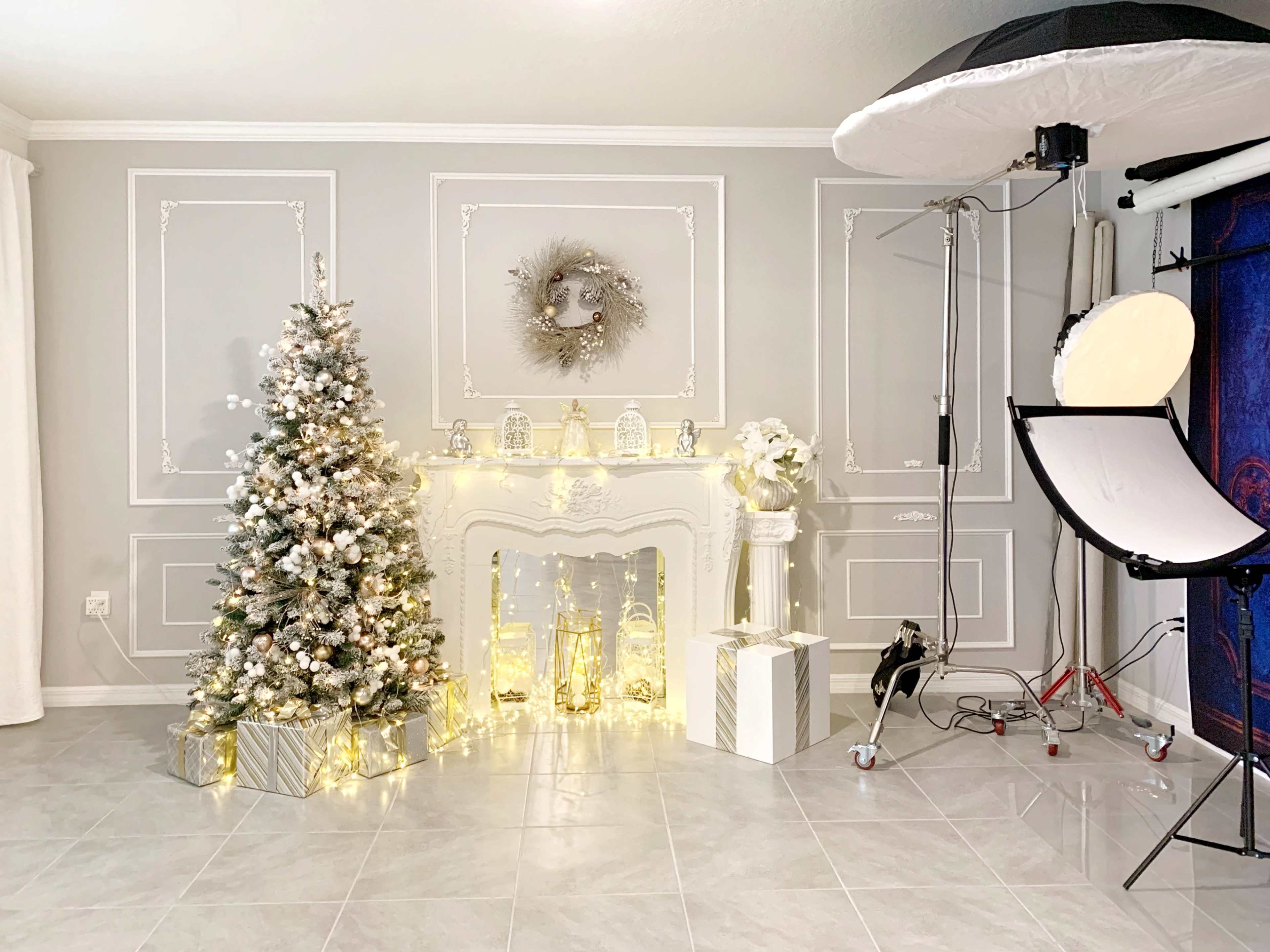 The image shows a festive setting with a decorated Christmas tree, a white fireplace, and various holiday decorations including lanterns and wrapped gifts.