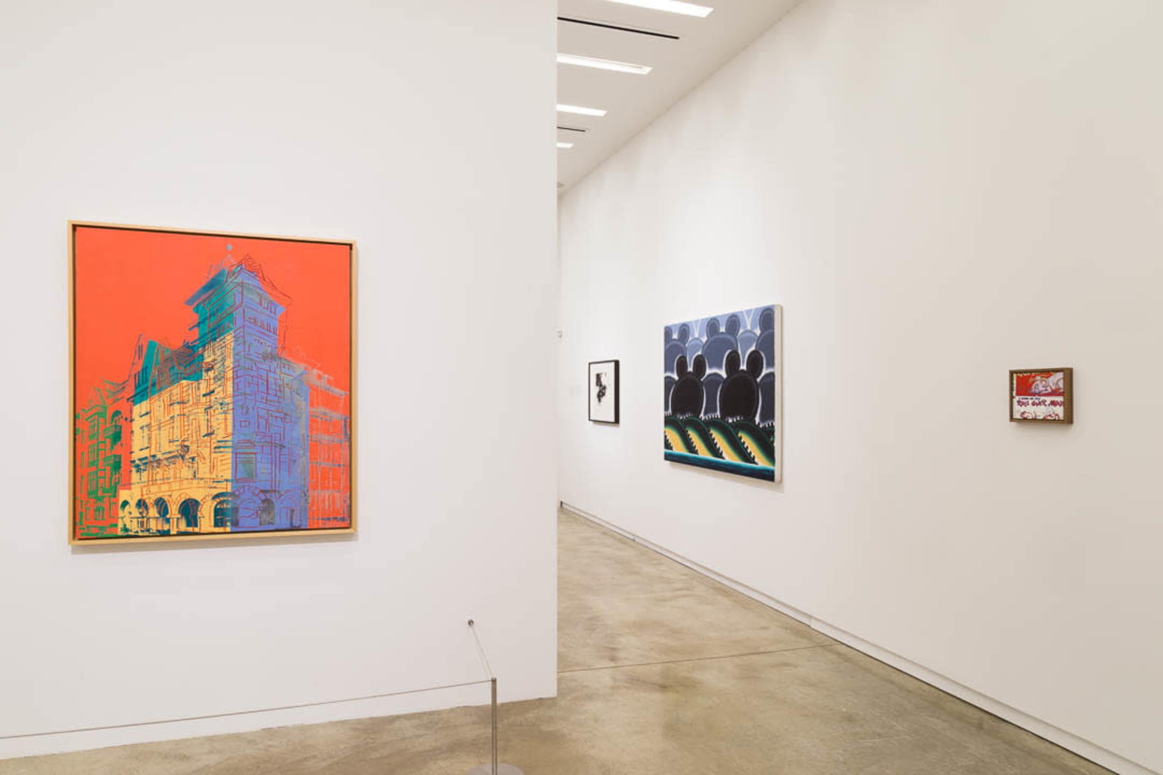 The image shows an art gallery with three distinct artworks displayed on white walls, featuring a vibrant red and orange piece on the left and two additional pieces on the right.