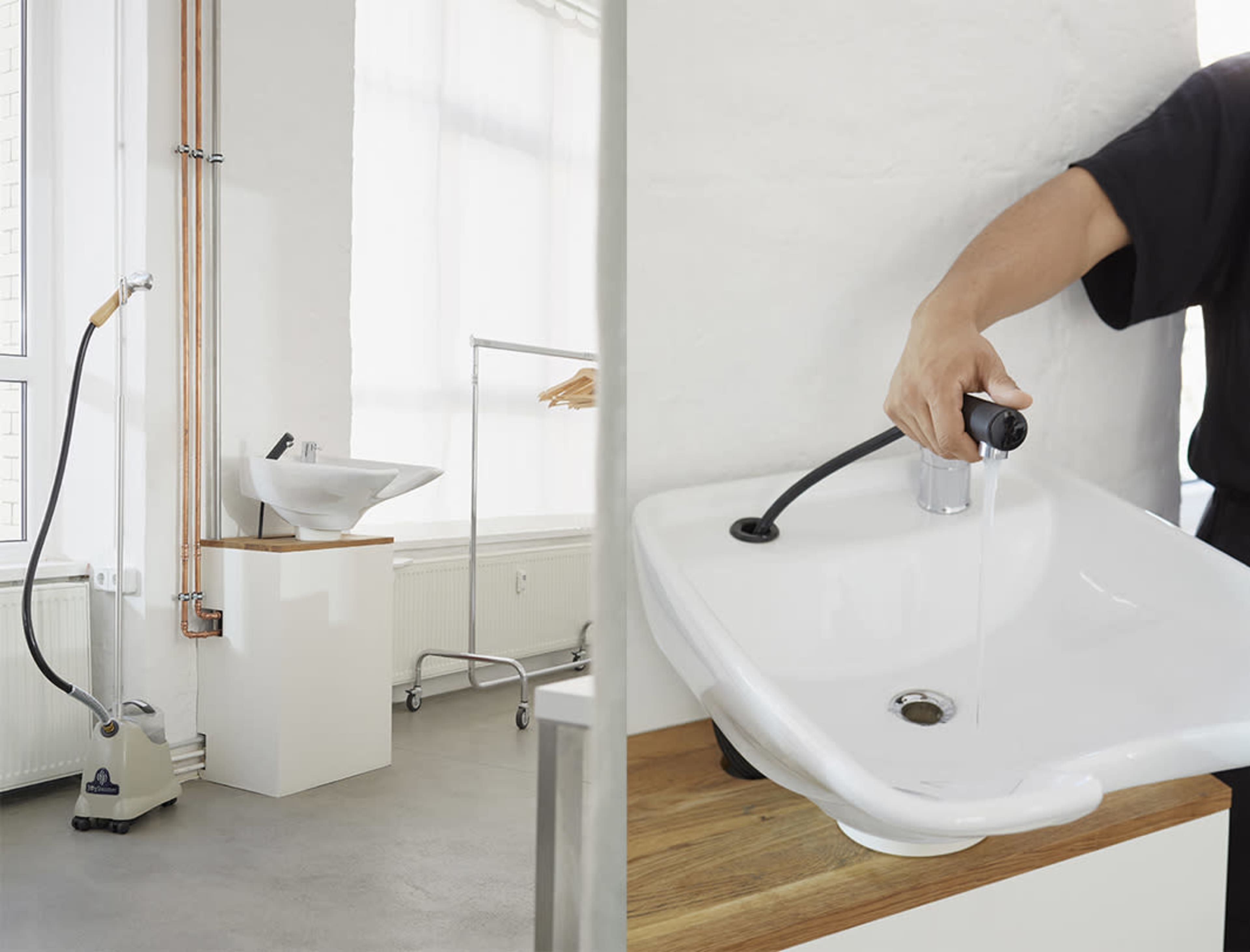 A modern bathroom setup featuring a white sink with a wooden countertop and a separate steam machine beside it.