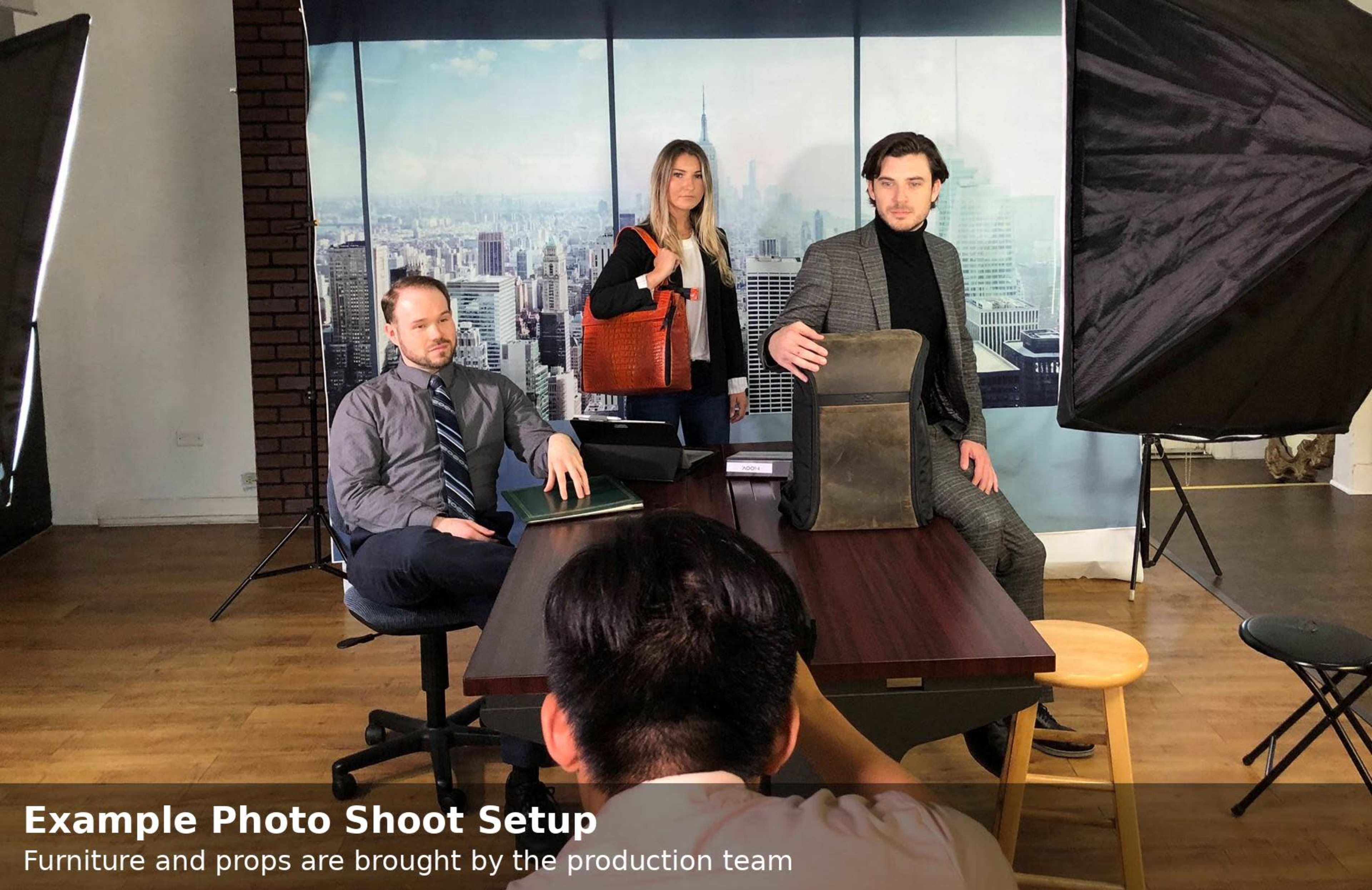 A group of three models poses in a studio setting with urban backdrop, furniture, and lighting equipment.