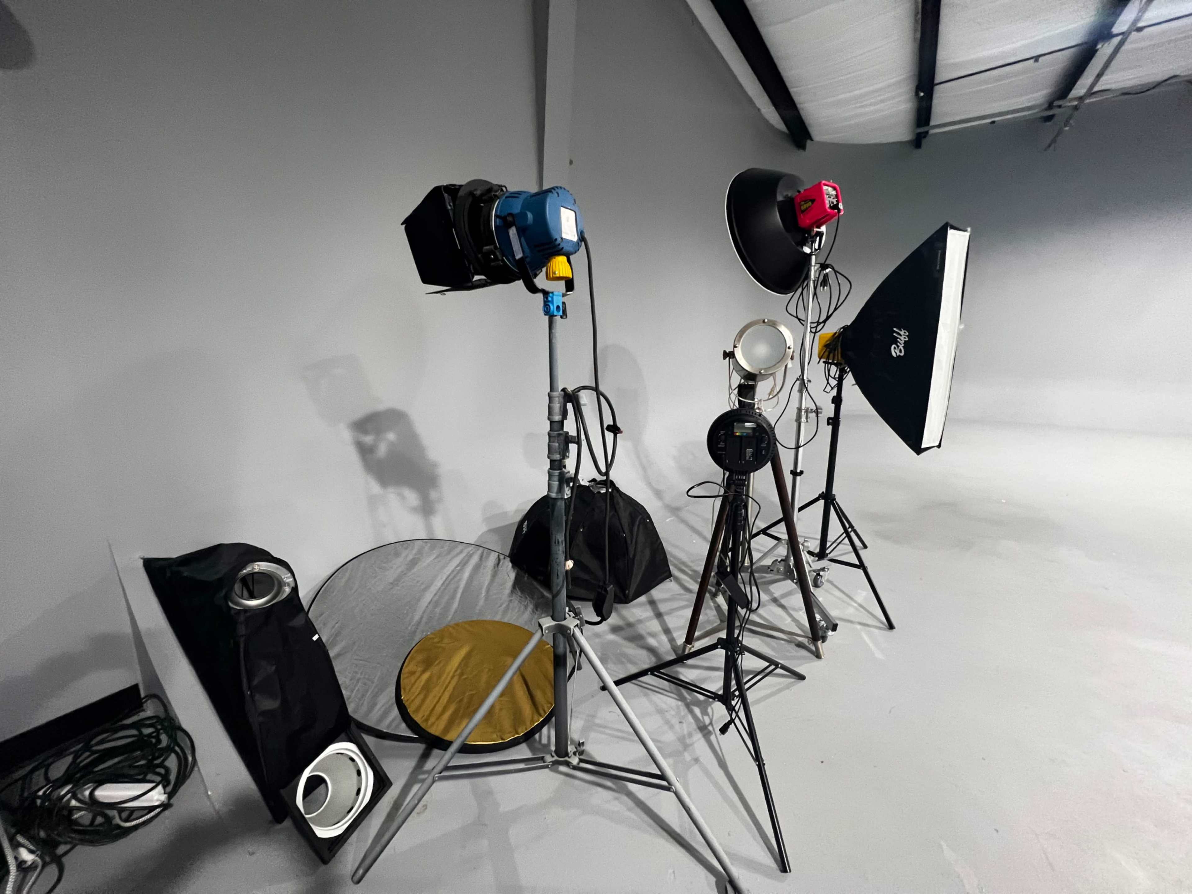 Various studio lighting equipment arranged against a gray backdrop.