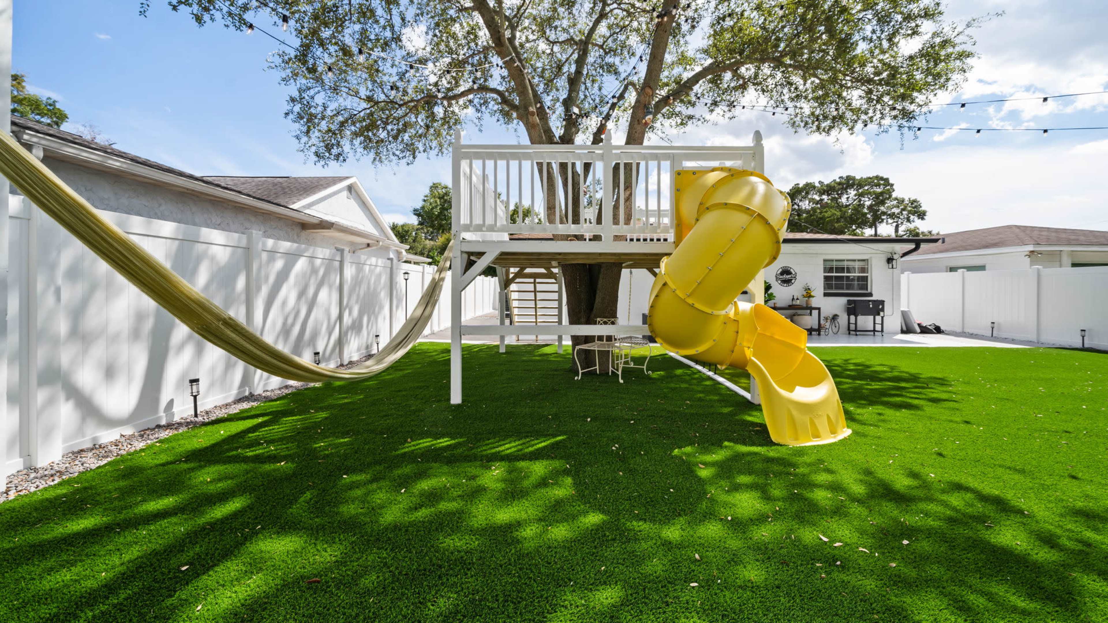 Spacious Backyard with Open Roof Treehouse Playground Image in Westshore, tampa, FL