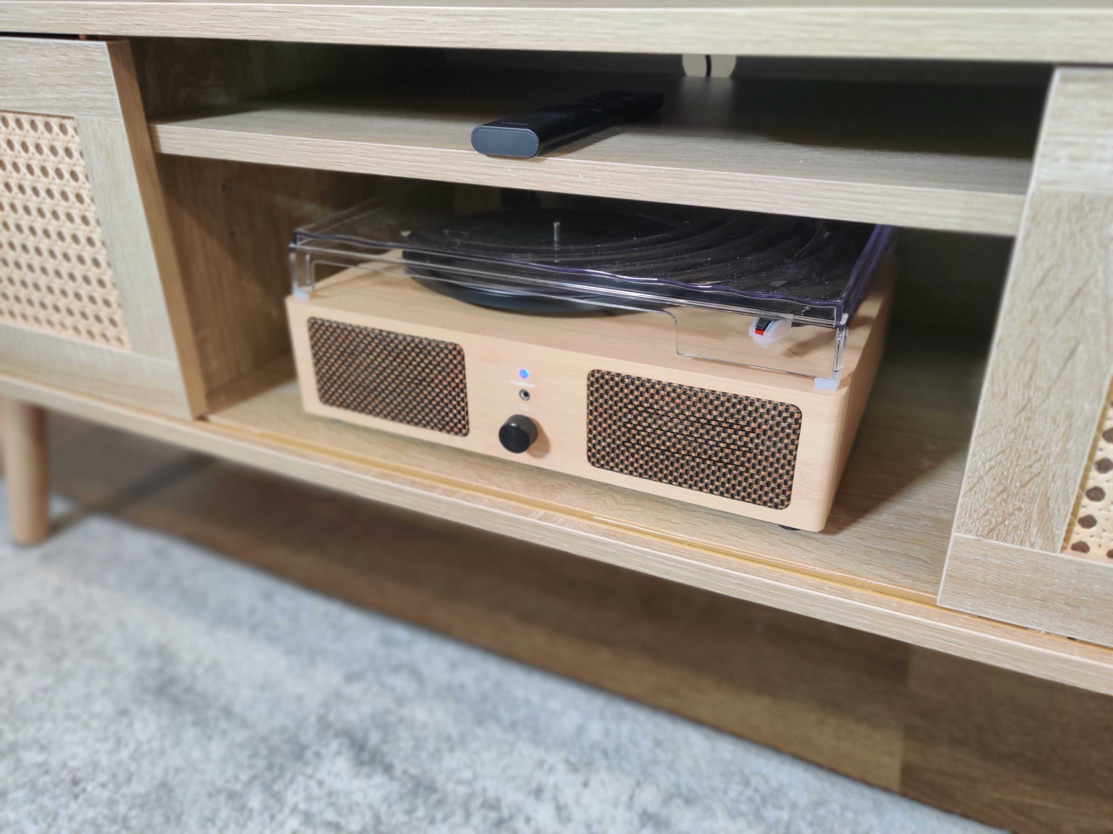 A wooden media console with a turntable placed inside a shelf.