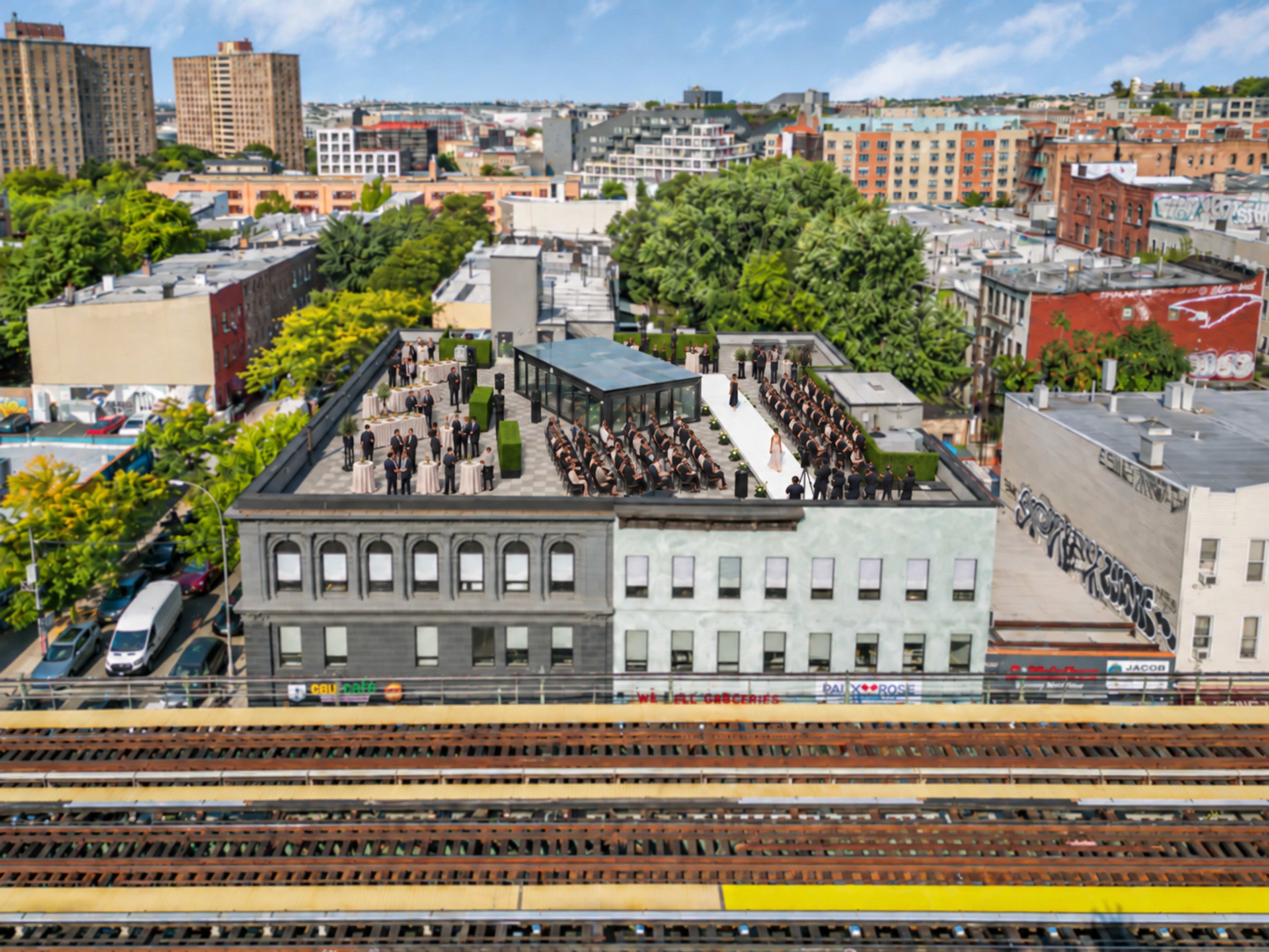 An aerial view shows a rooftop event with attendees gathered on a building overlooking an urban landscape.
