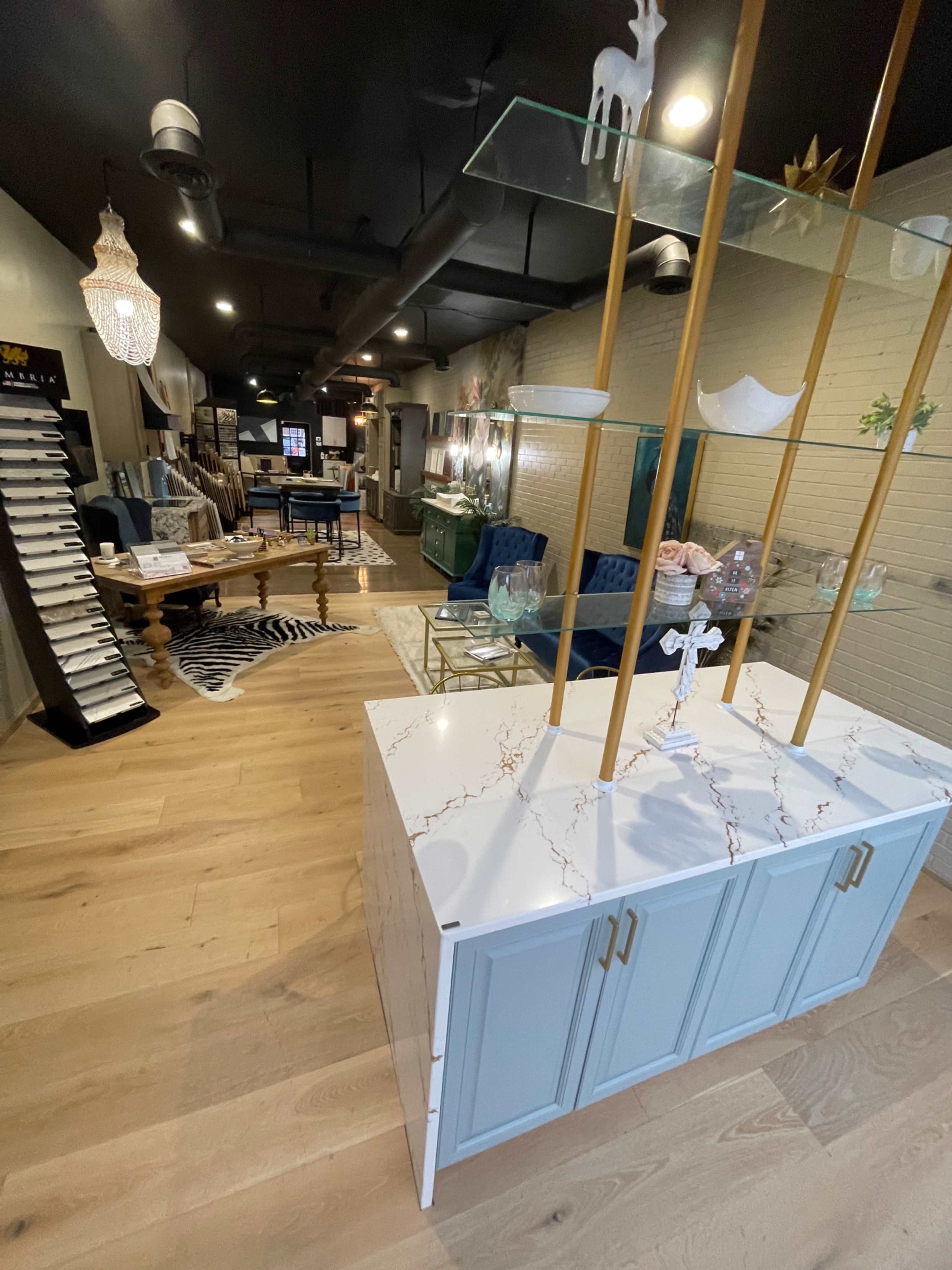 A modern furniture store interior featuring a display cabinet and various seating arrangements arranged around a central area.
