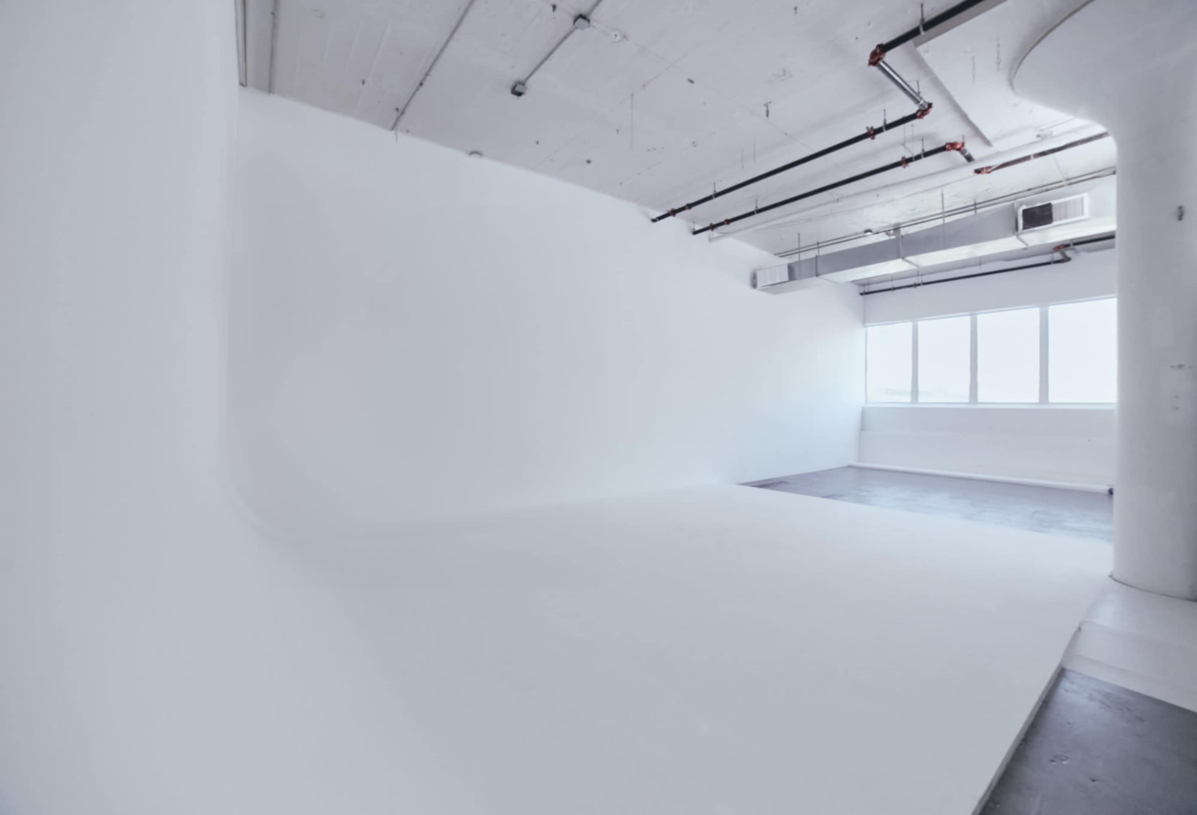 All white photo/video studio with CYC wall and concrete floors. White Rabbit Studio Image in Long Island City, Long Island City, NY