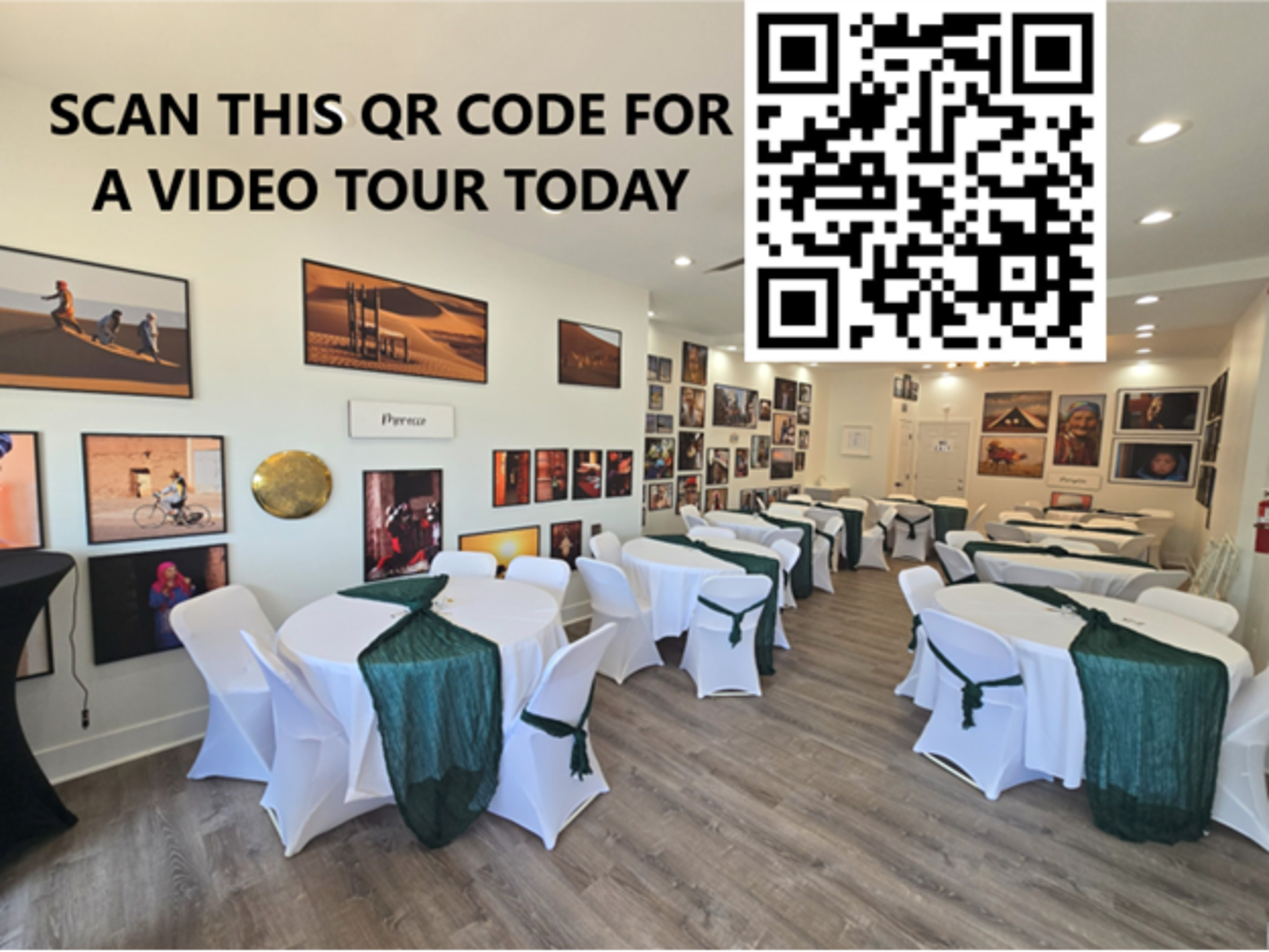 The image shows a brightly lit room arranged with several tables covered in white tablecloths and green accents, adorned with framed photographs on the walls and a QR code inviting viewers to scan for a video tour.