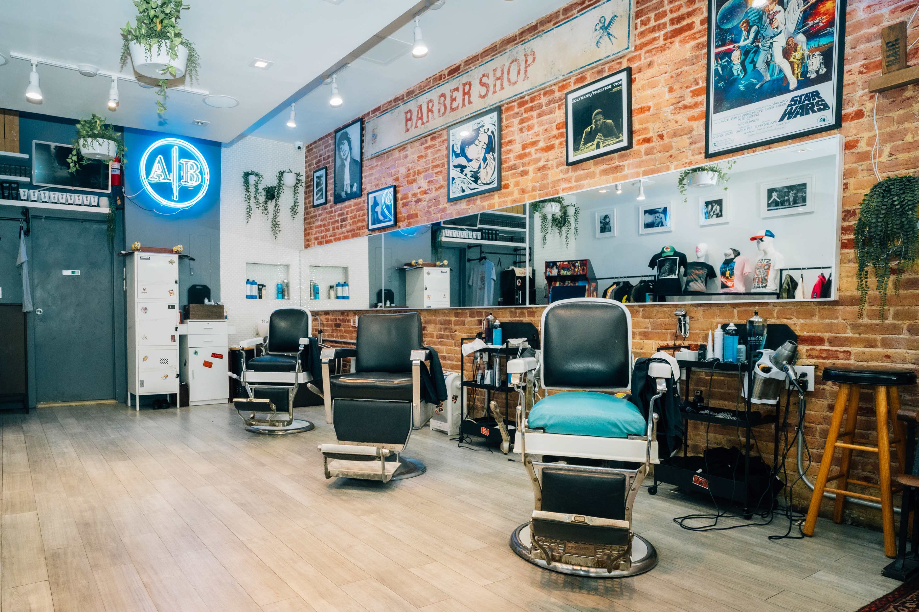 A barbershop interior with three vintage barber chairs, a brick background, and various decorations on the walls.