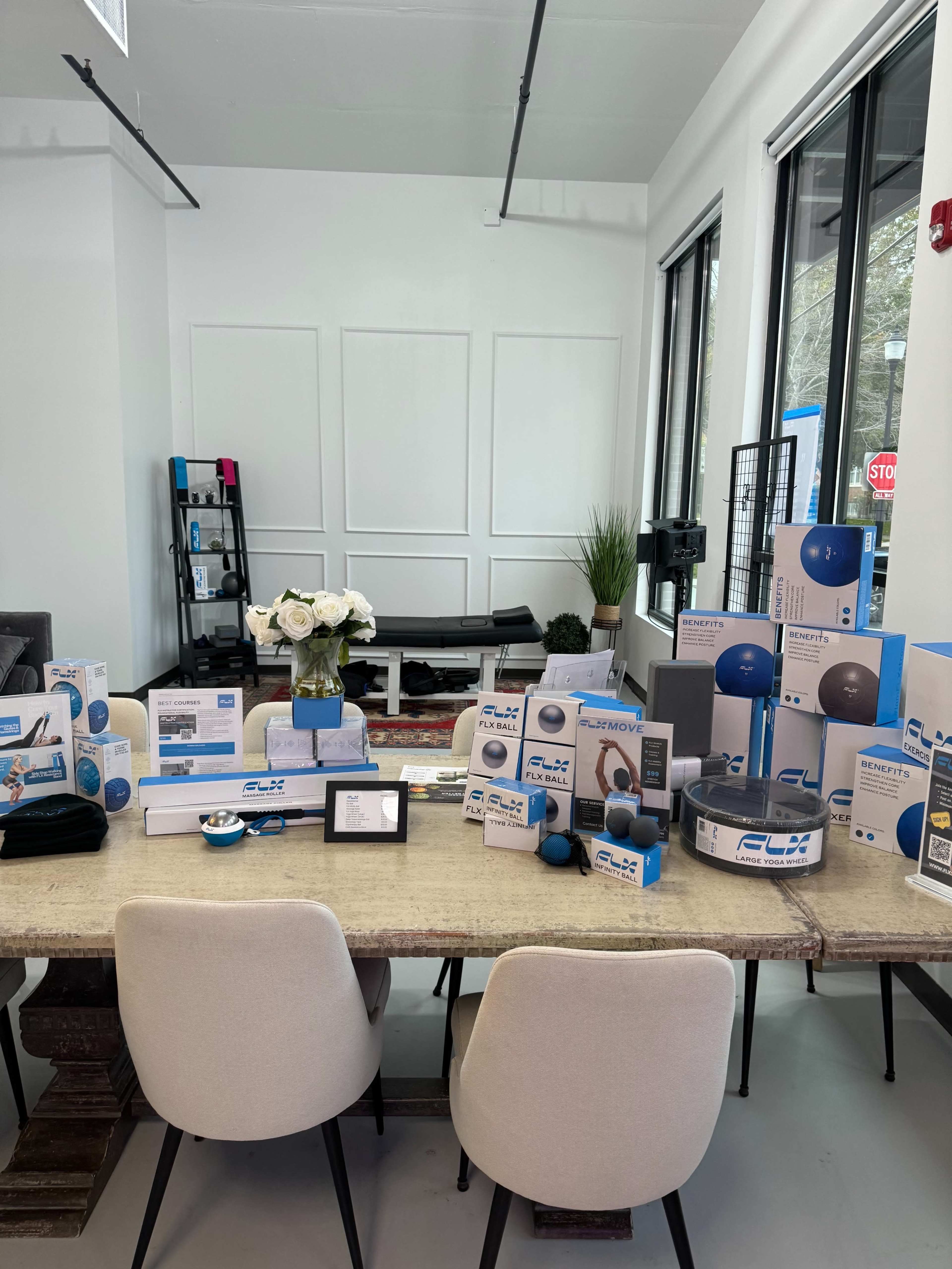 A modern interior features a table displaying various audio equipment and accessories, surrounded by minimalistic decor.