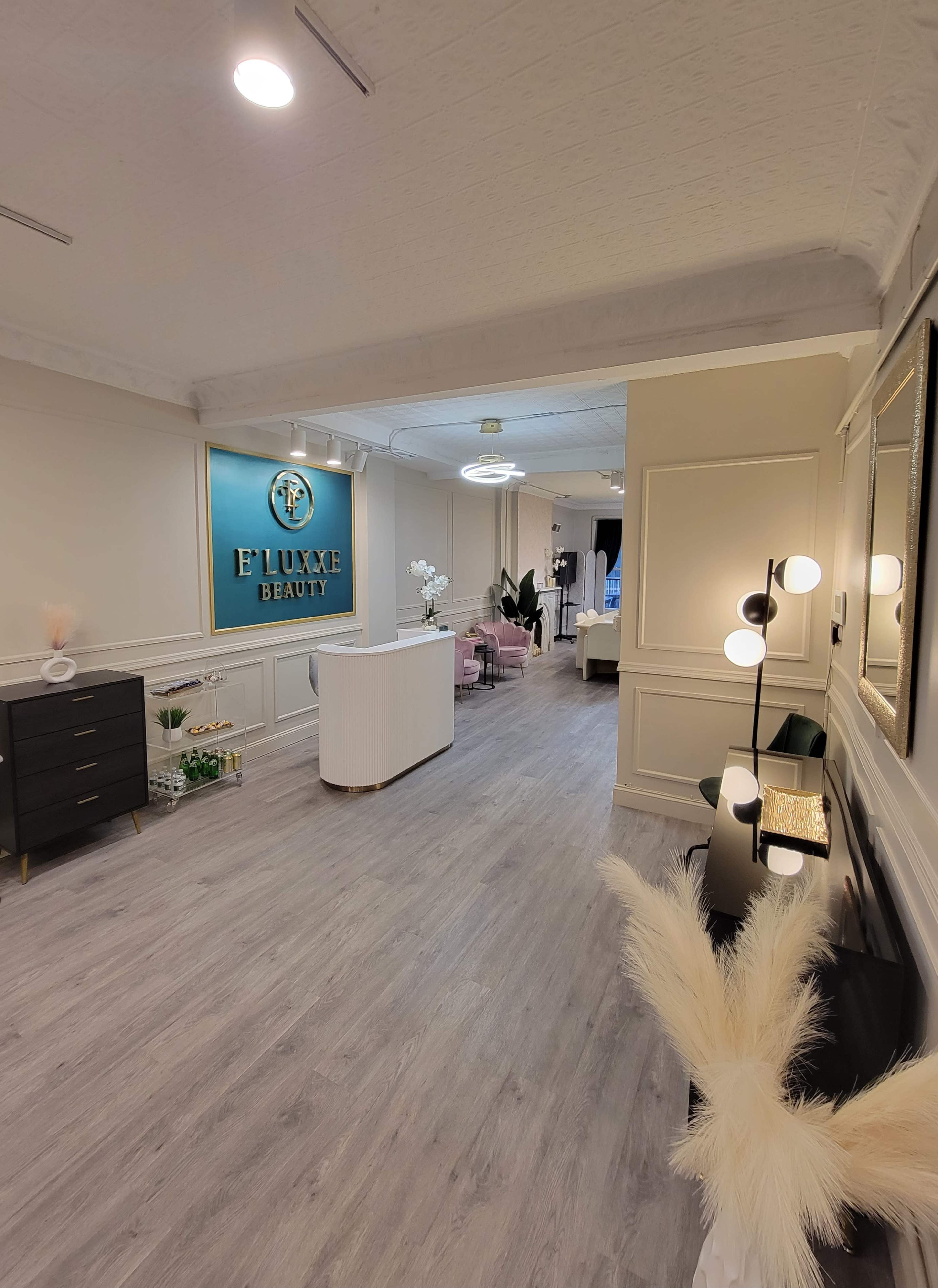 The image shows a modern beauty salon interior with stylish furnishings, offering a bright and inviting atmosphere.