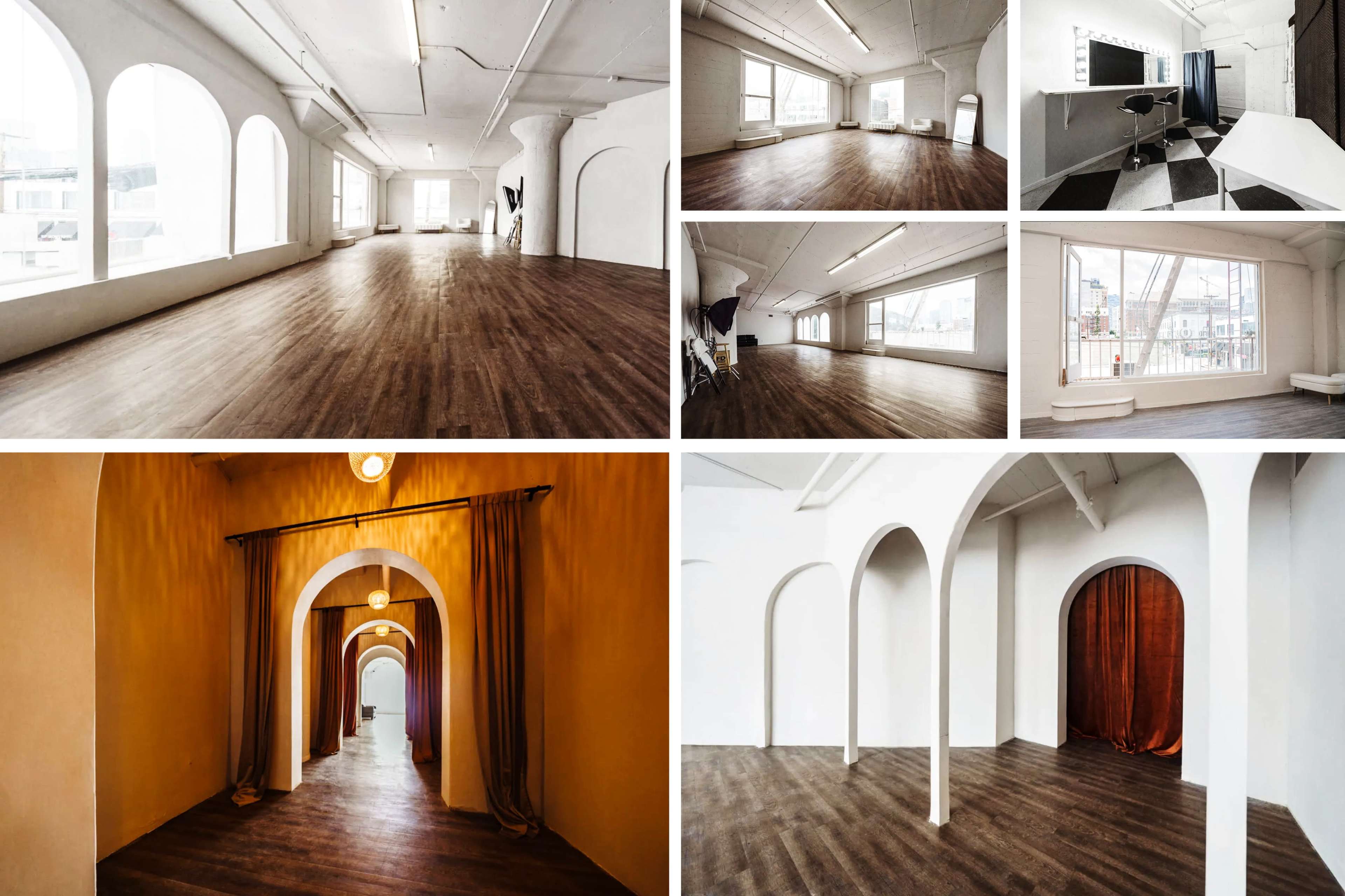 A spacious, well-lit studio with wooden flooring, featuring arched doorways and large windows.