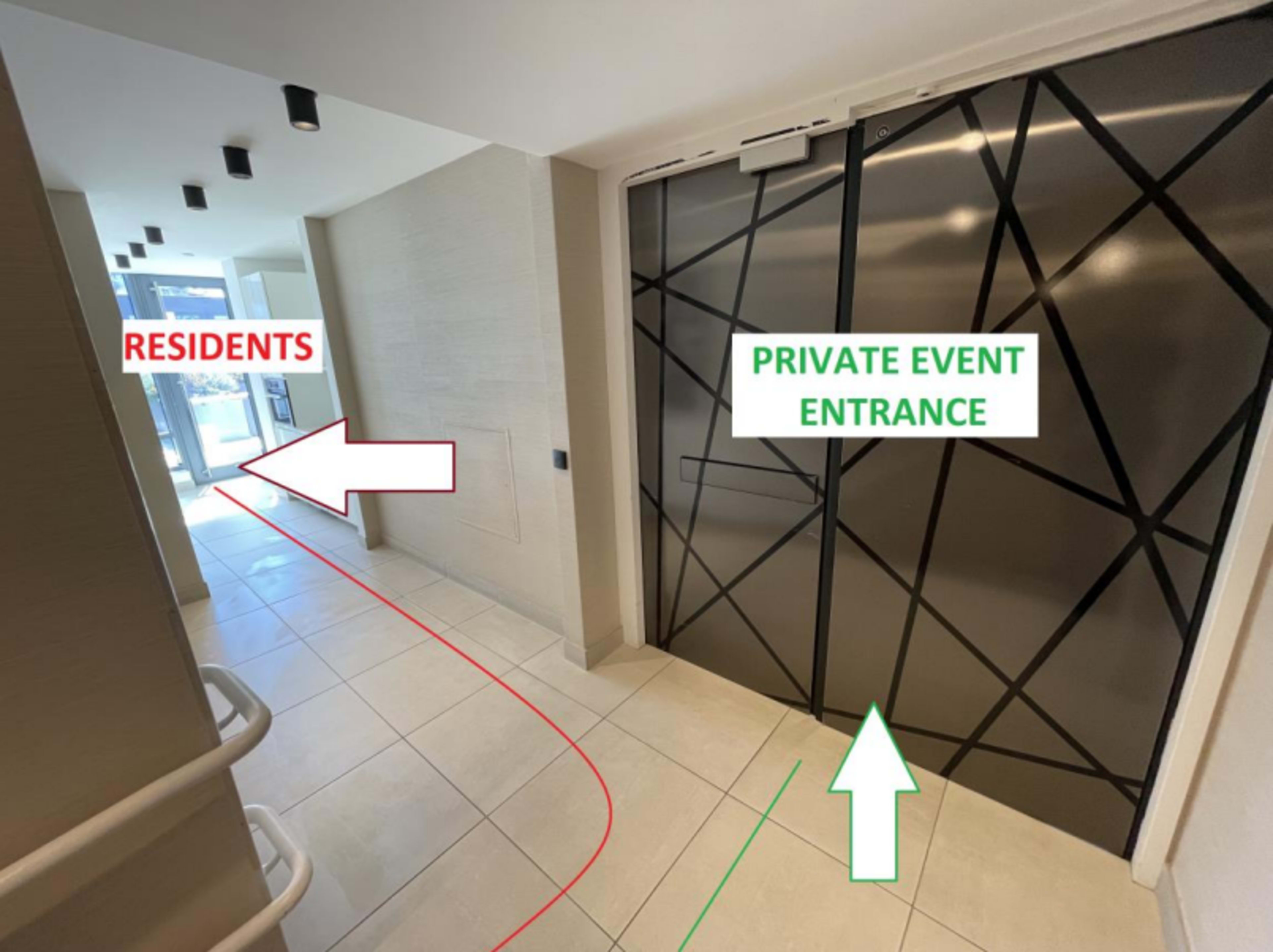 A corridor with directional arrows indicating the entrances for residents and a private event.