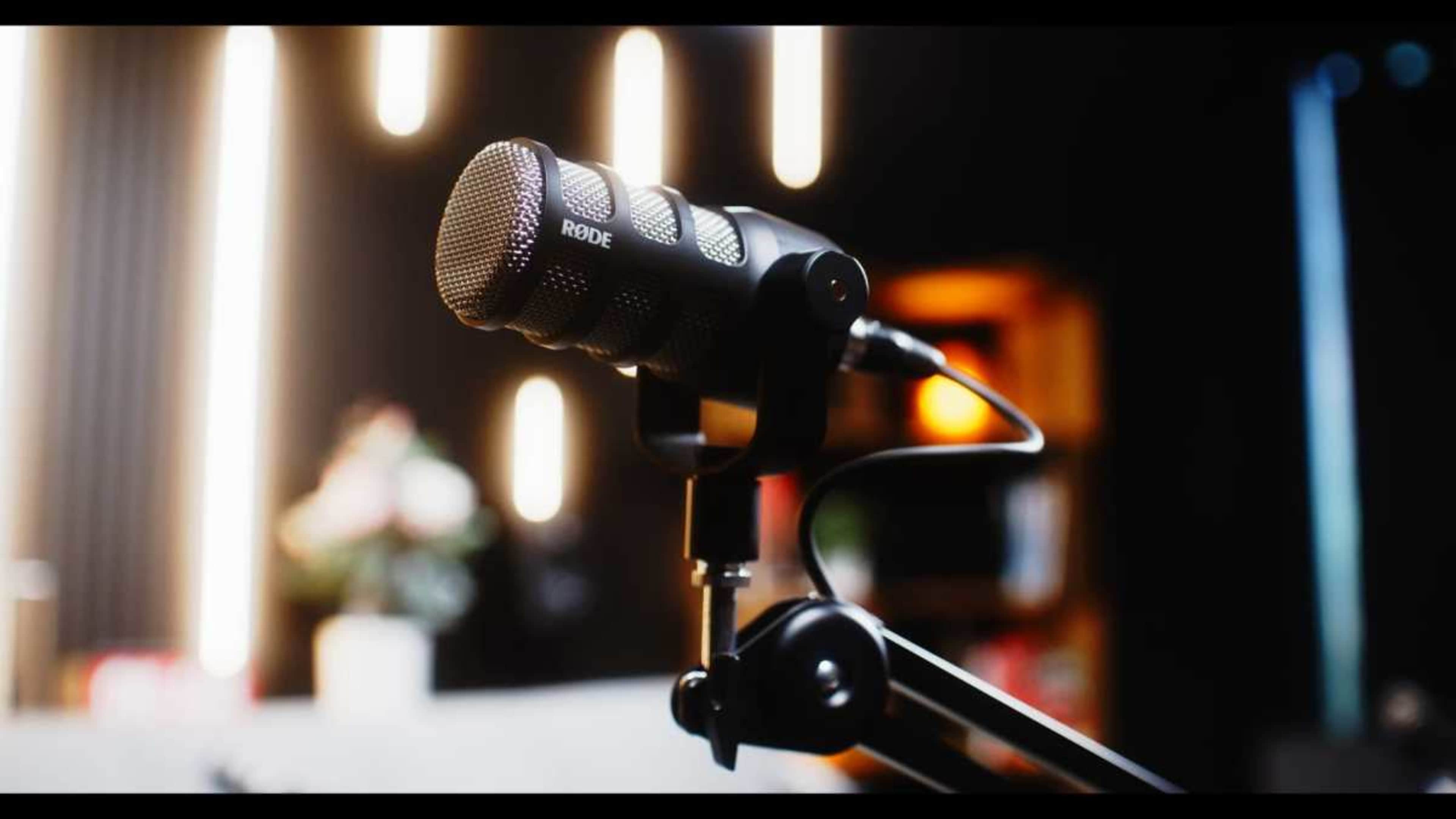A close-up of a Rode microphone mounted on an adjustable arm.