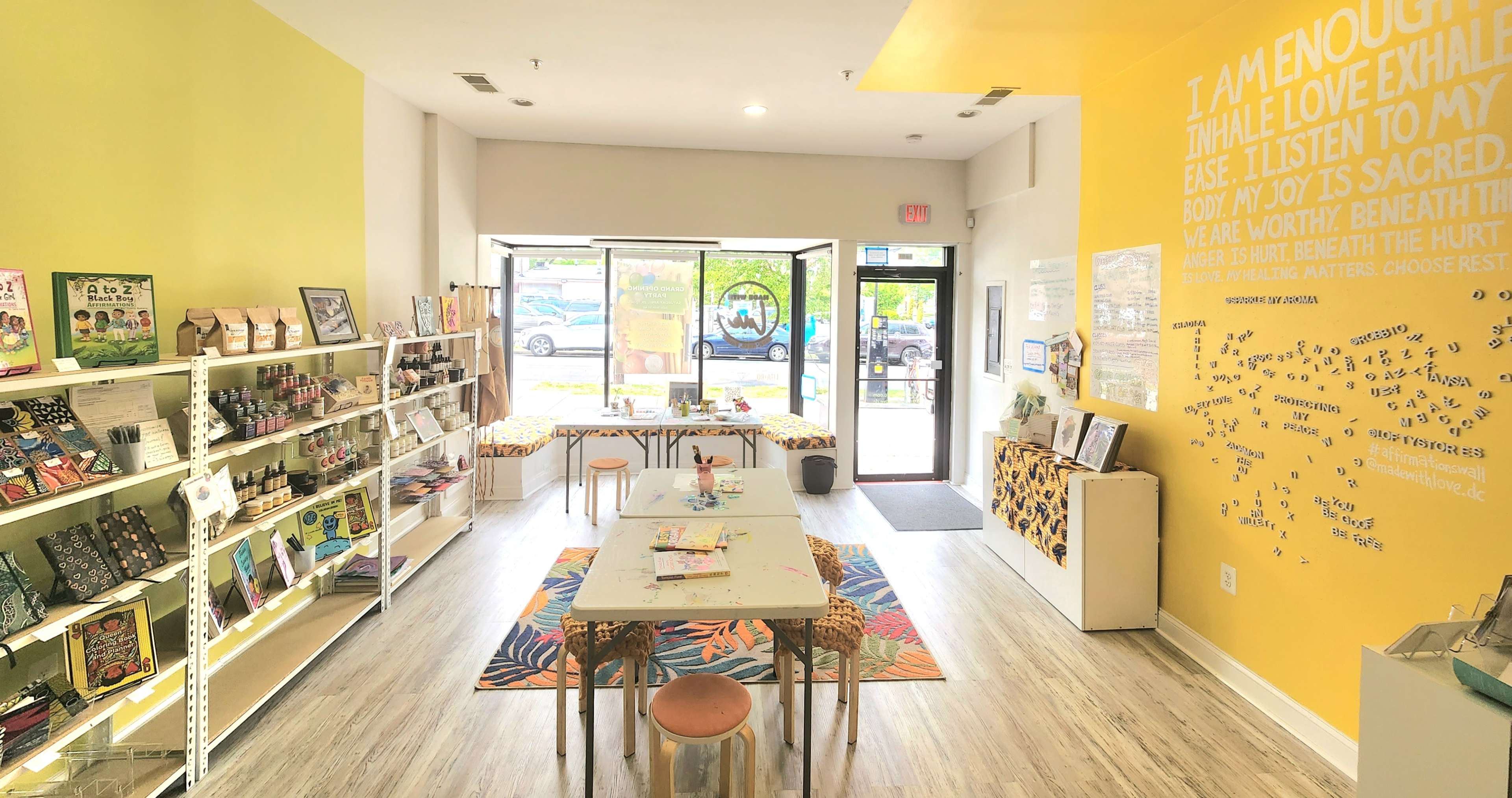 A bright interior of a wellness shop with shelves filled with products, a central table, and motivational quotes on the walls.