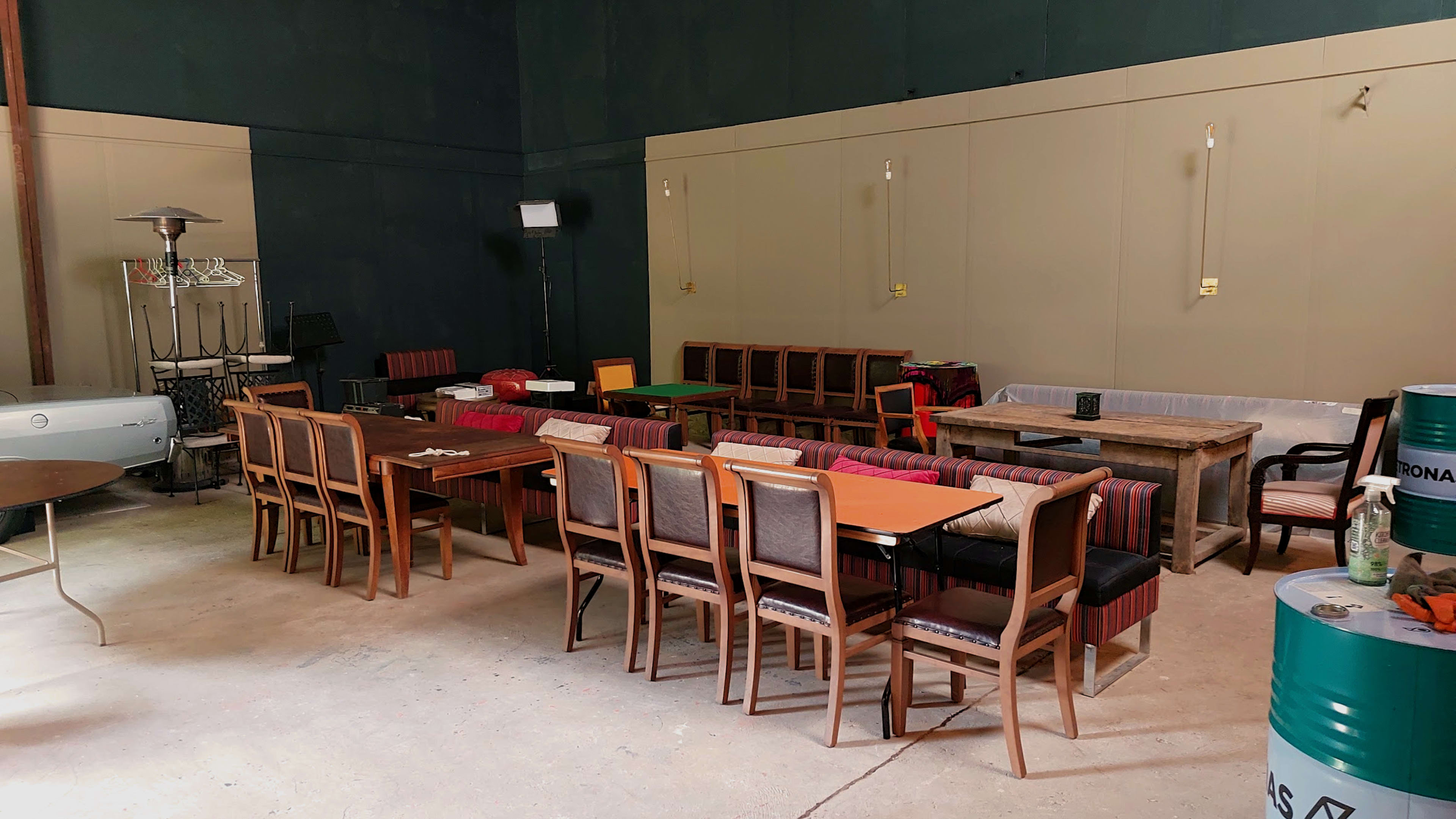 The image shows a spacious indoor area furnished with various tables and chairs arranged in different configurations.