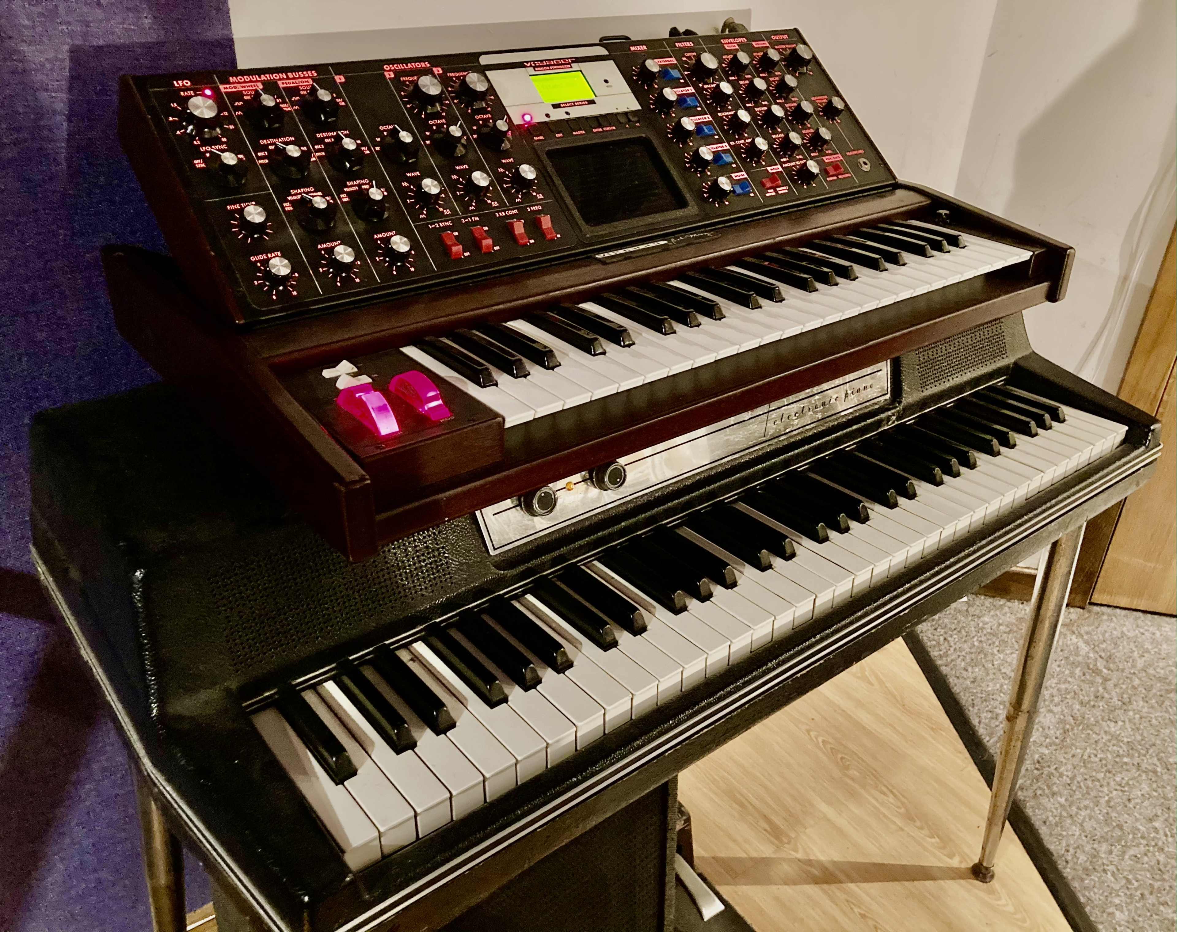 A two-tier keyboard setup featuring a synthesizer on top and a digital piano on the bottom.