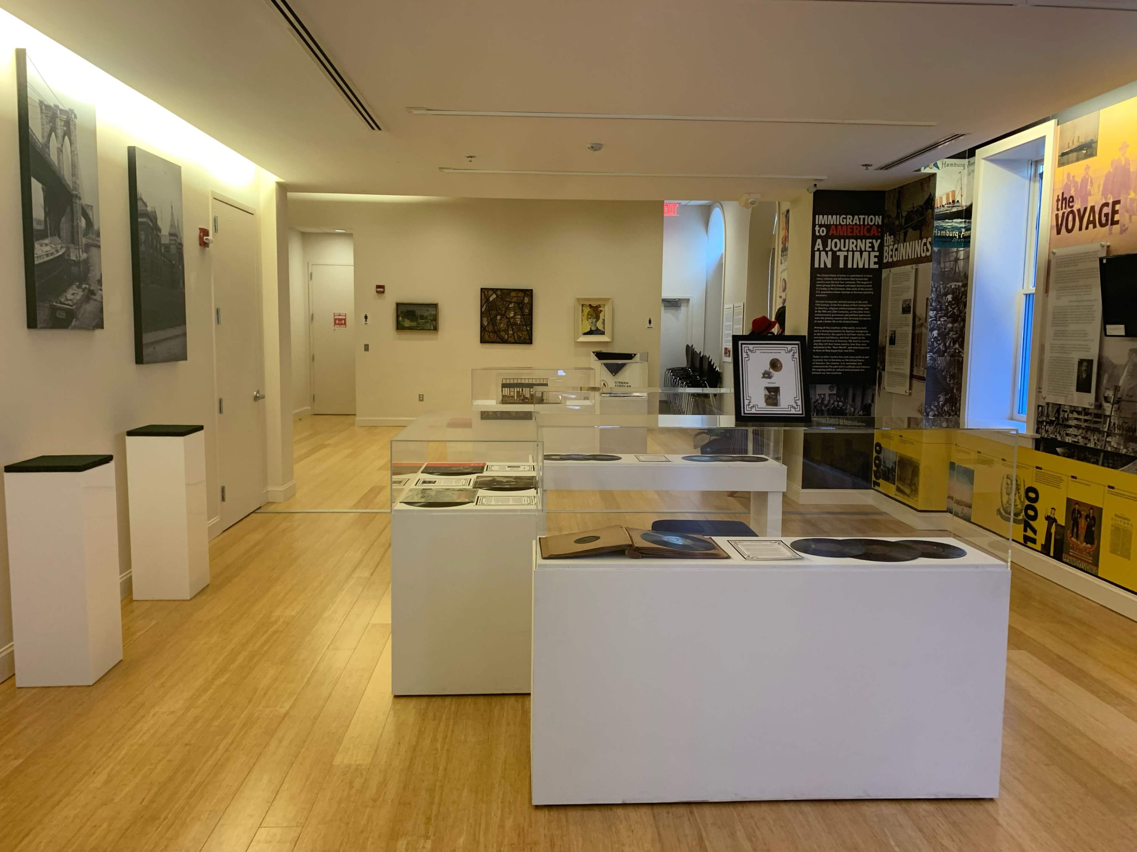 An exhibition space with display cases featuring various artifacts and informational panels in a museum setting.
