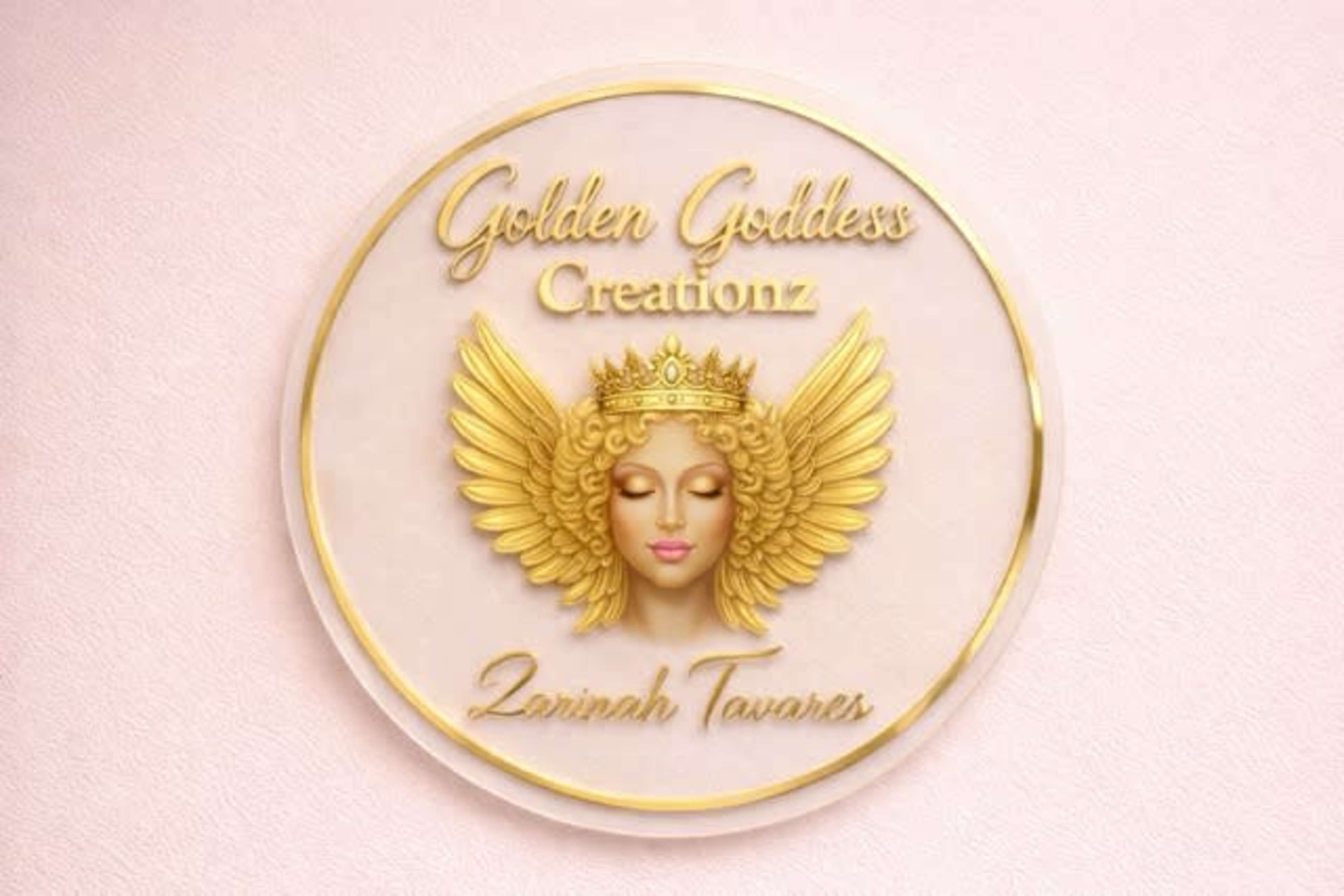 The image features a circular logo with a central depiction of a golden-winged goddess face, surrounded by the text "Golden Goddess Creationz" and the name "Zarinah Tavares."