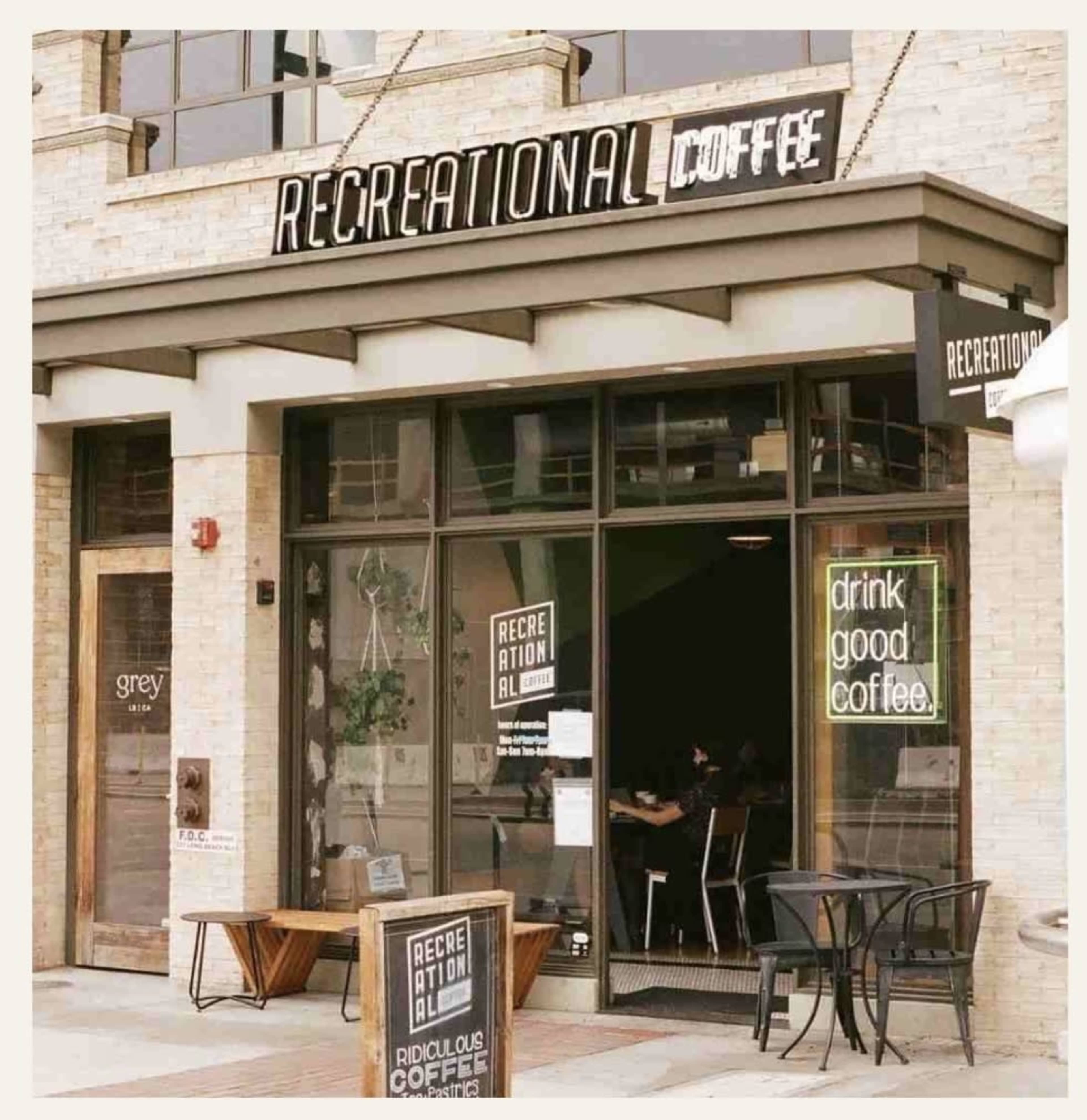 A coffee shop named "Recreational Coffee" features large glass windows with a sign that invites customers to "drink good coffee."