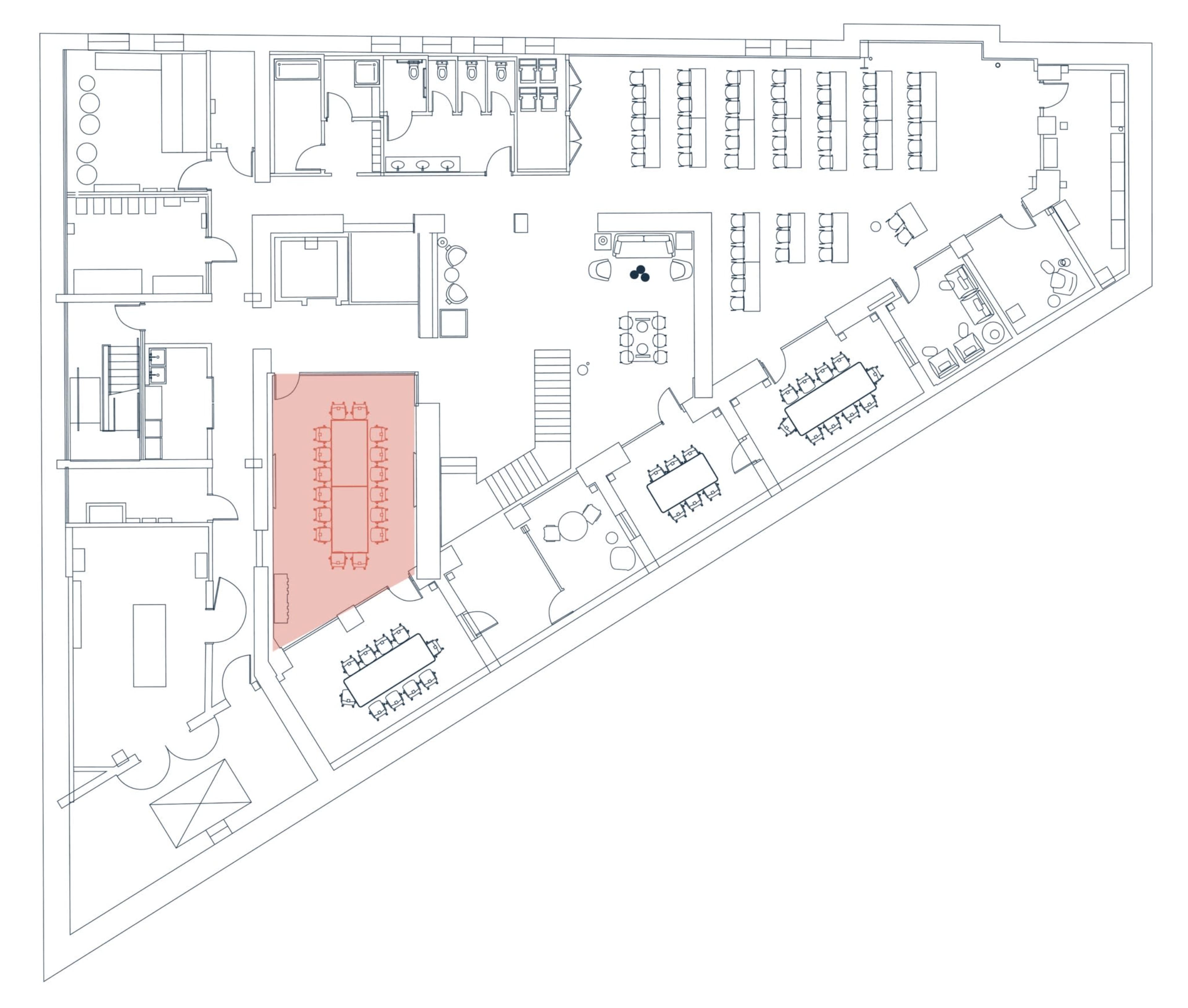 The image depicts a floor plan of an office layout, highlighting a central conference area in red.