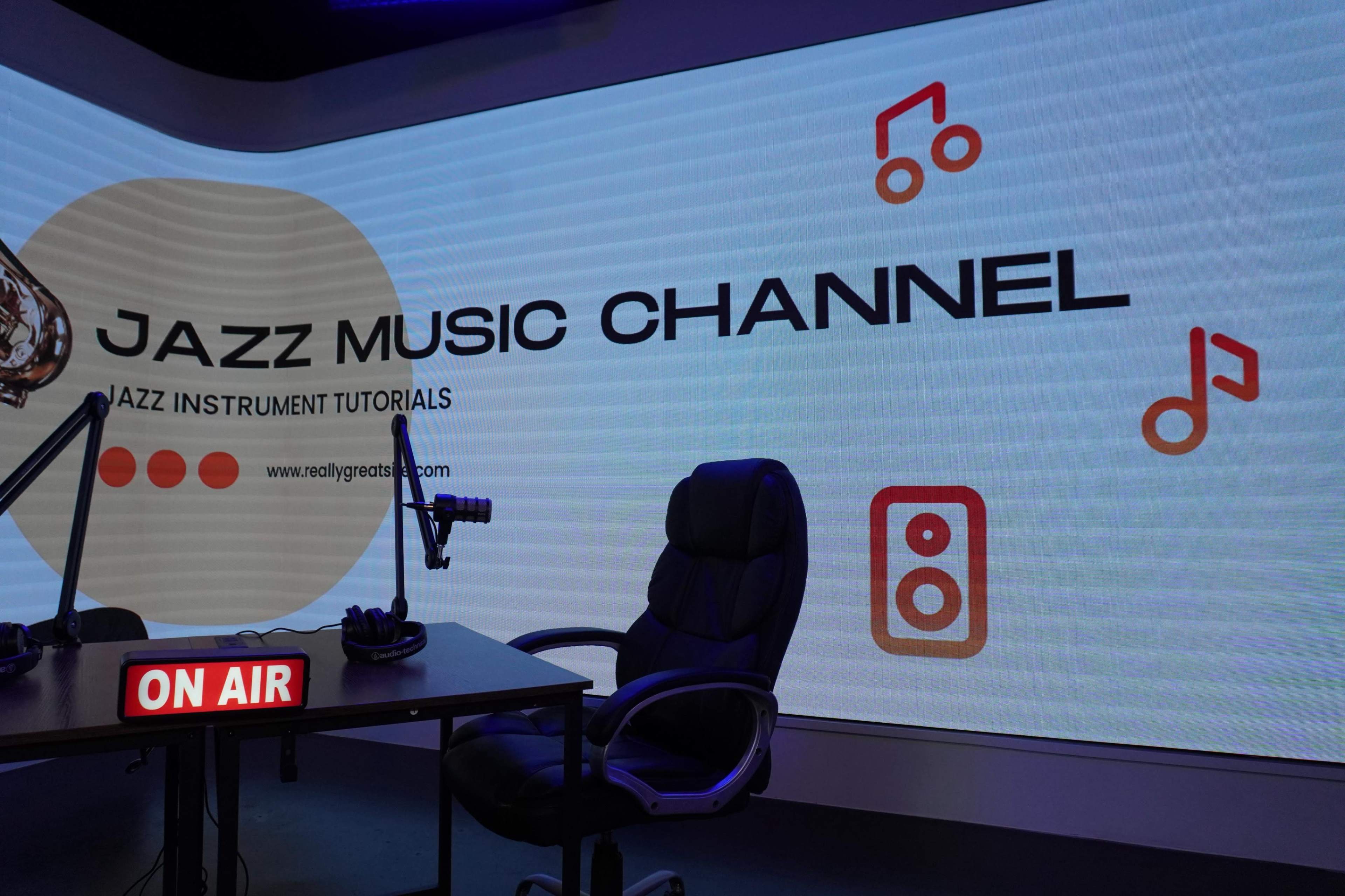 The image shows a studio setup for a jazz music channel, featuring a microphone, an empty chair, and a large displayed logo with text promoting jazz music tutorials.