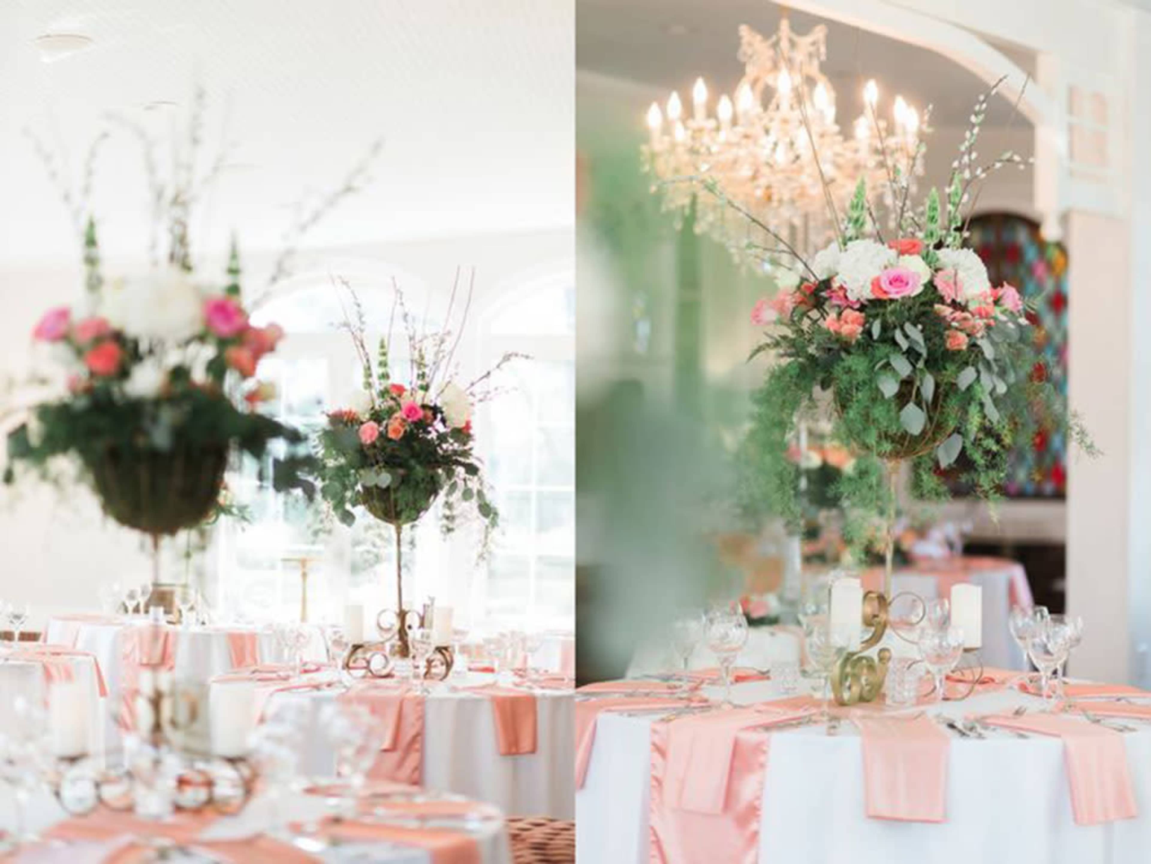 Elegantly arranged tables with floral centerpieces and soft pink table linens in a well-lit banquet setting.