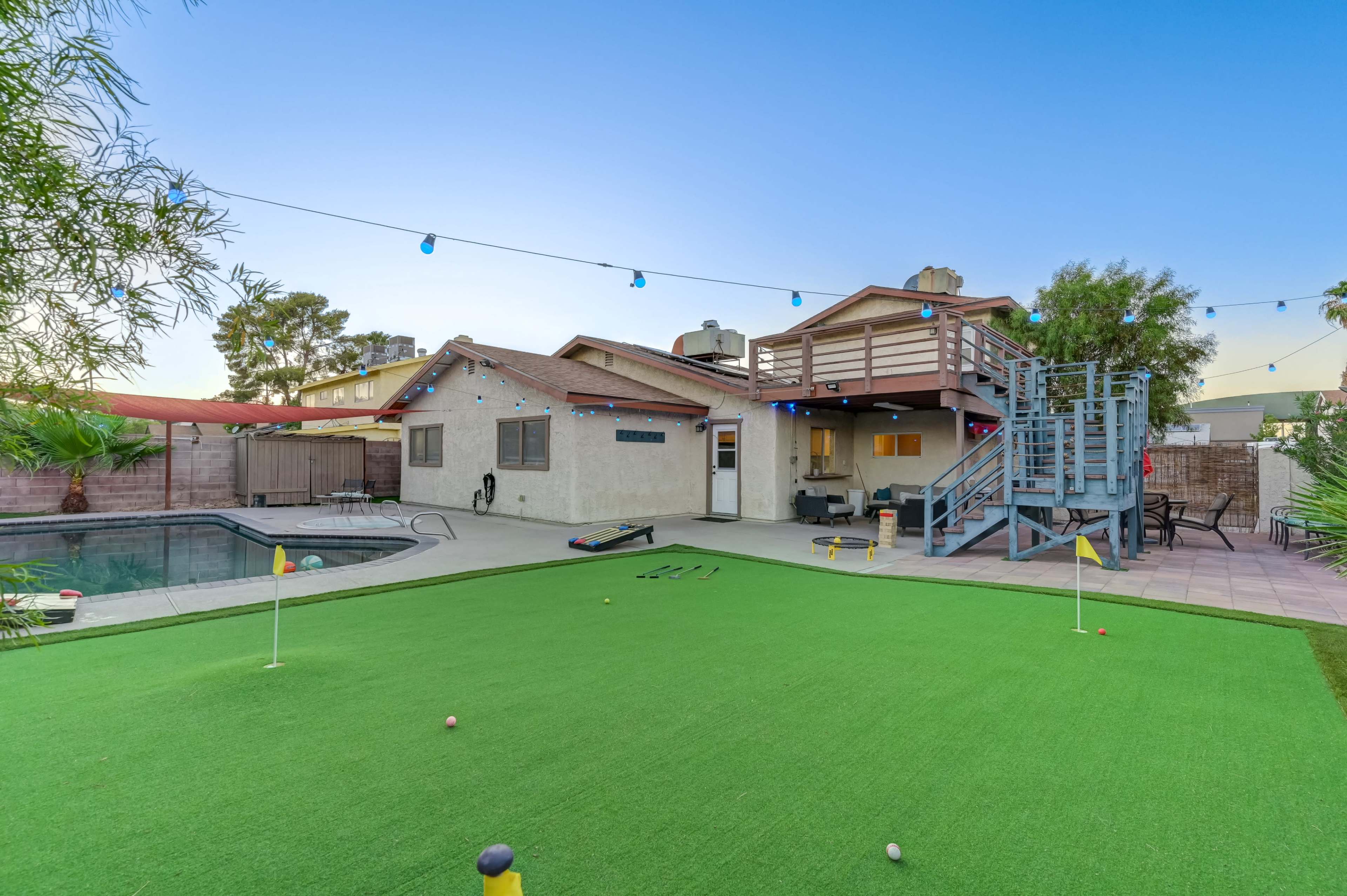 Oasis backyard with putting green, pool/spa/patio area/color string lights etc. Image in Spring Valley, las vegas, NV