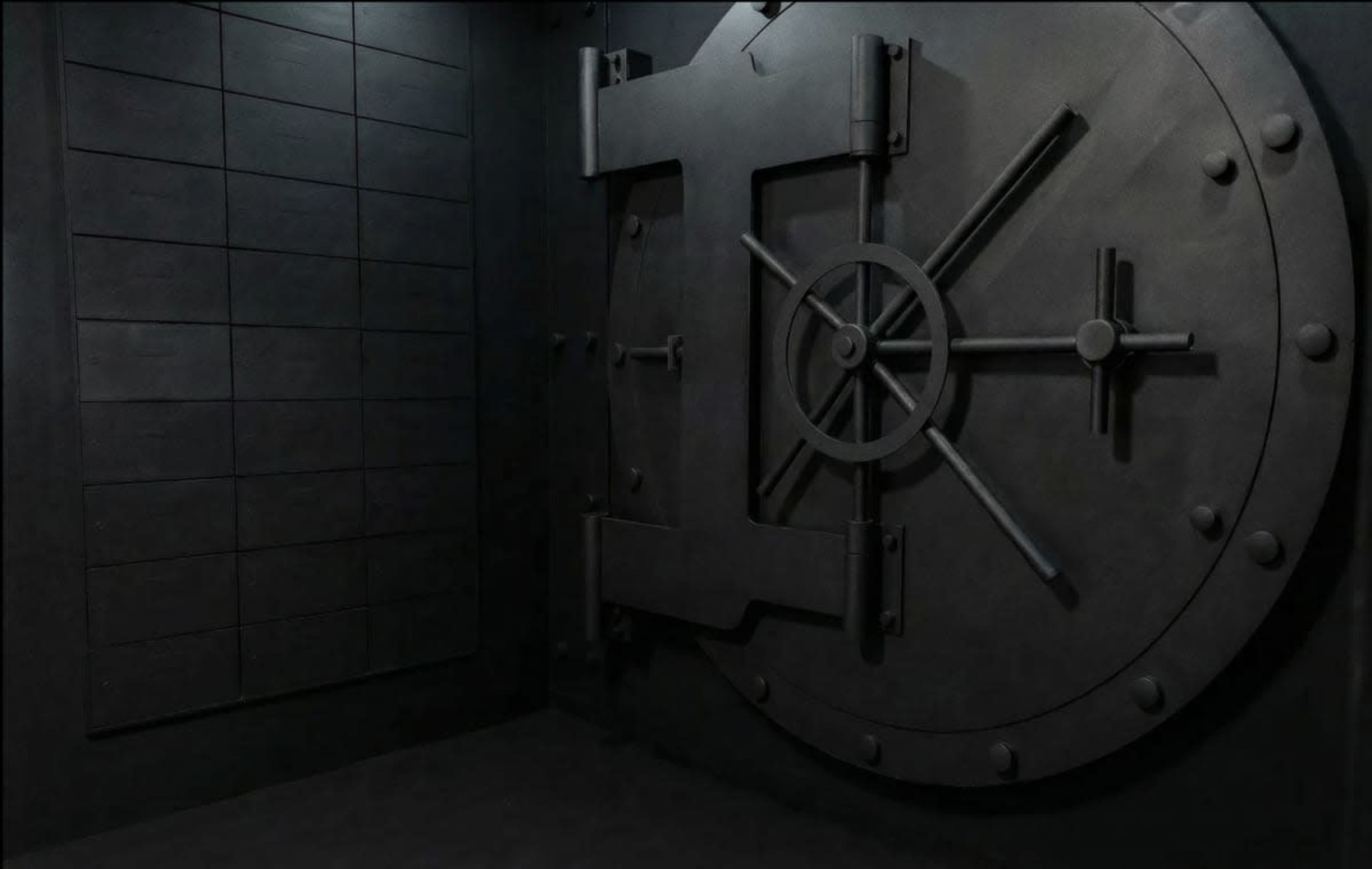 The image shows a large, closed vault door set against a dark, textured wall.