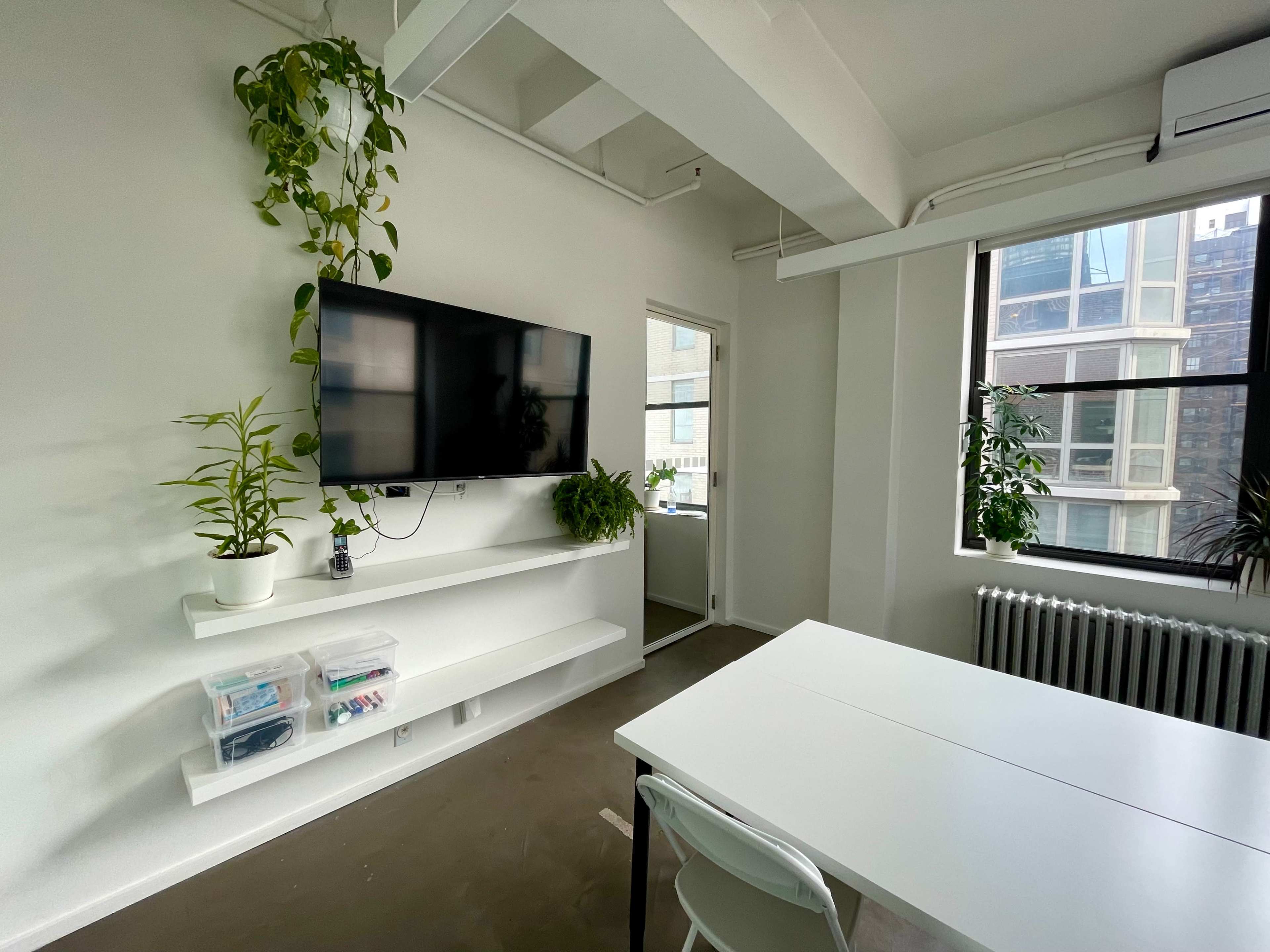 Light filled large meeting room with floor-to-ceiling white boards Image in Midtown Manhattan, New York, NY