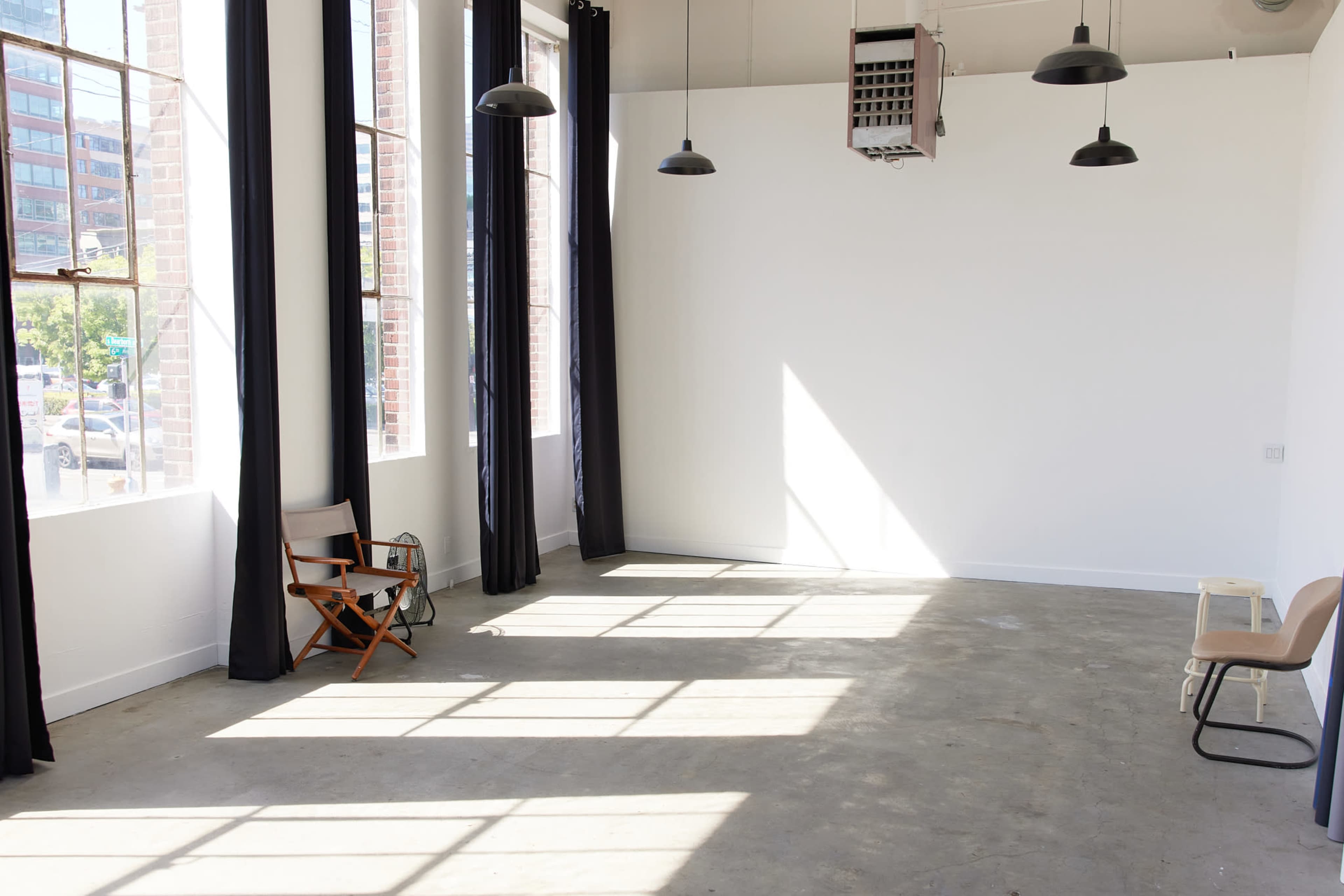 Clean White Studio with Concrete Floors & Natural Light Image in SODO, Seattle, WA