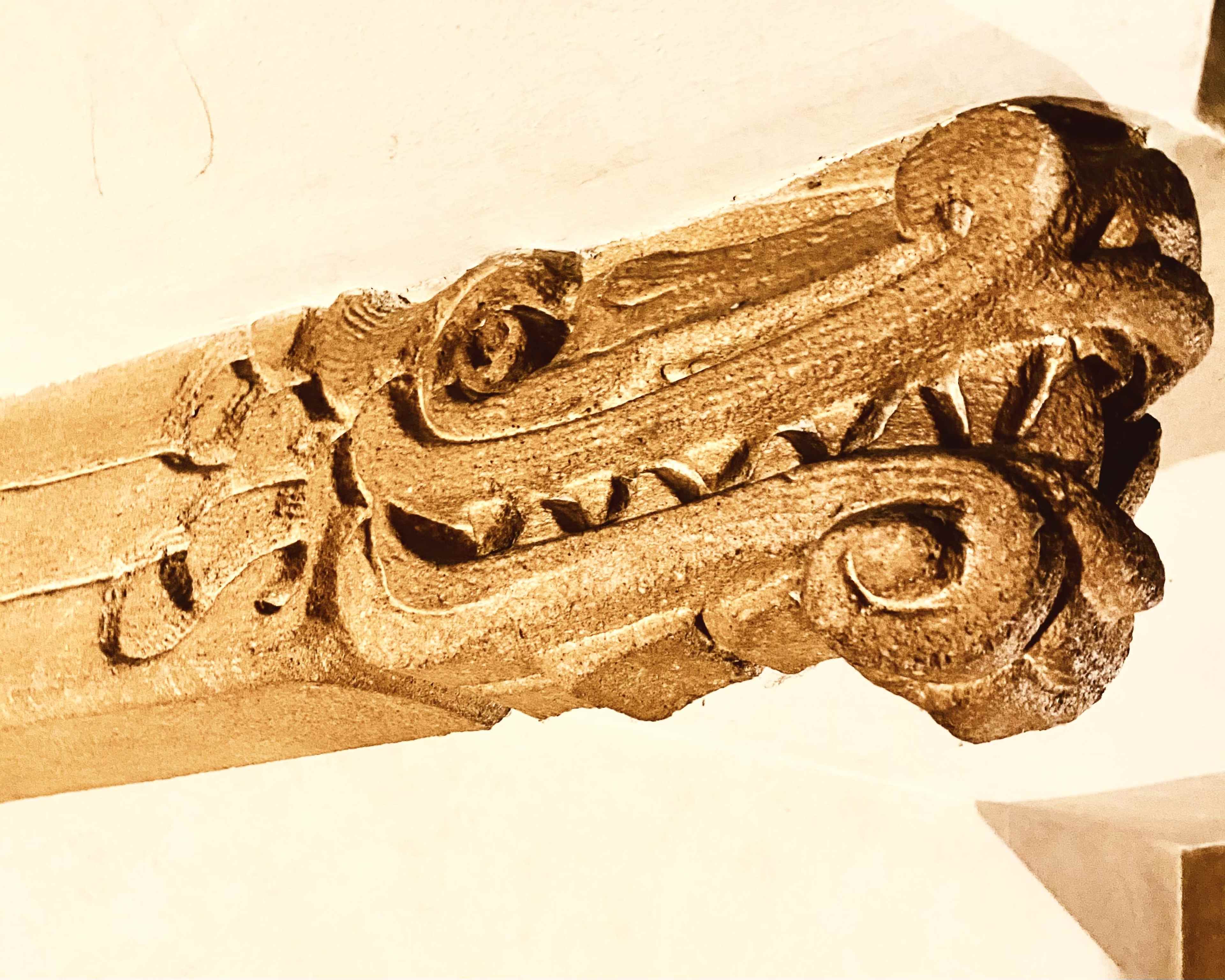 The image shows an intricately carved wooden bracket featuring decorative scrollwork and a dragon-like motif.