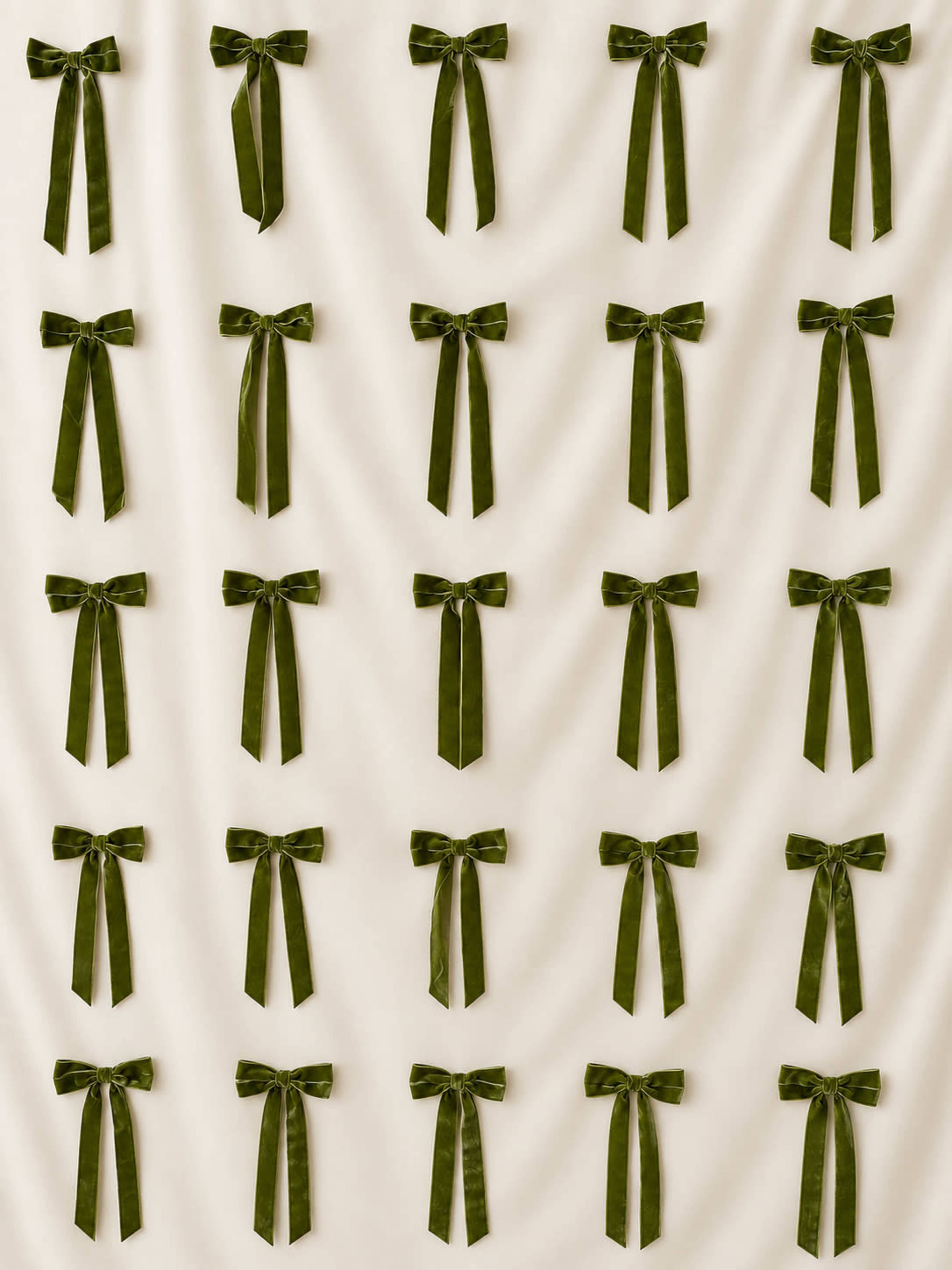 The image features a pattern of multiple dark green fabric bows arranged uniformly against a light beige background.