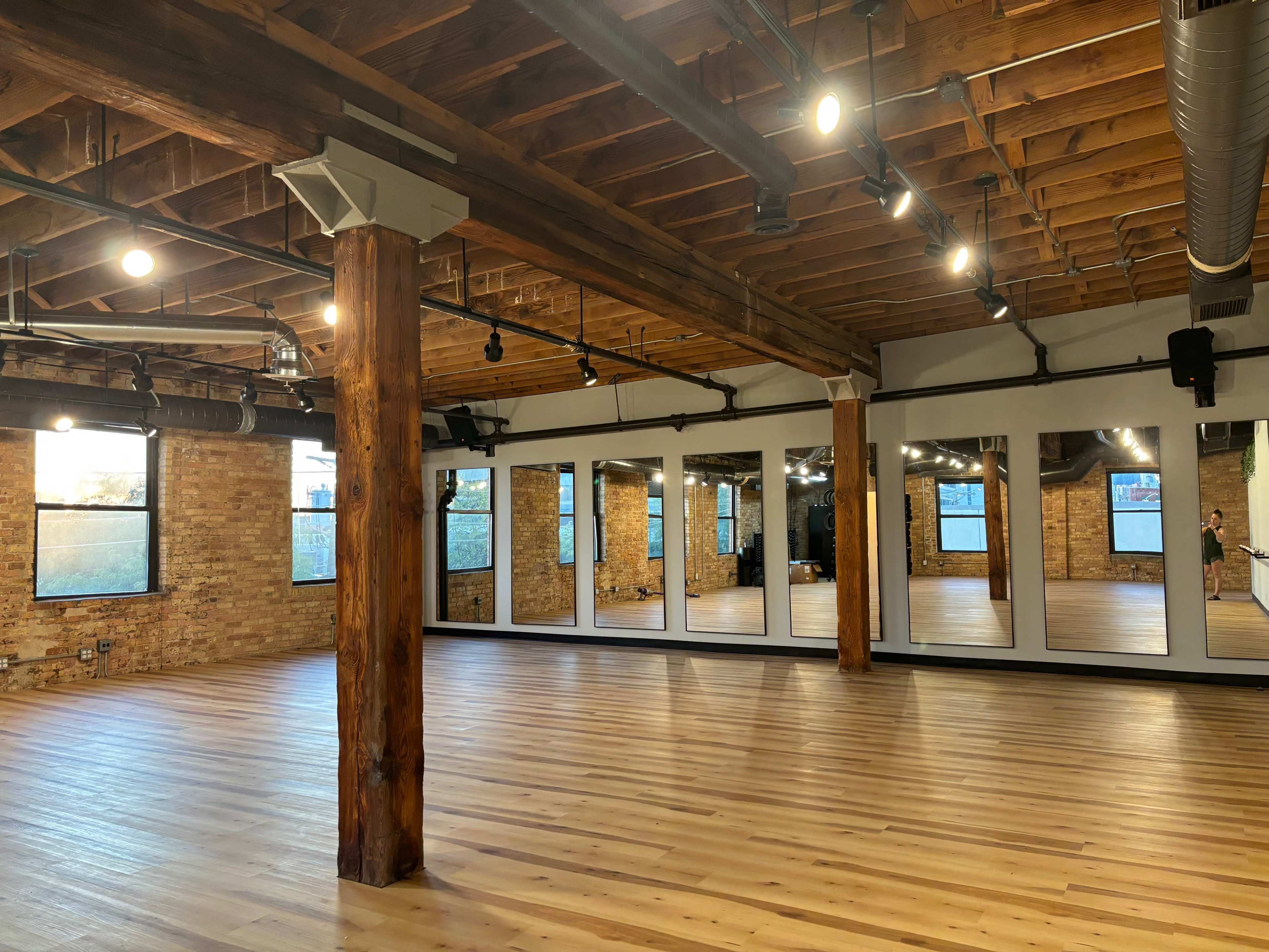 Beautiful timber loft fitness studio with equipment, skyline view and outdoor space. Image in Near North Side, Chicago, IL