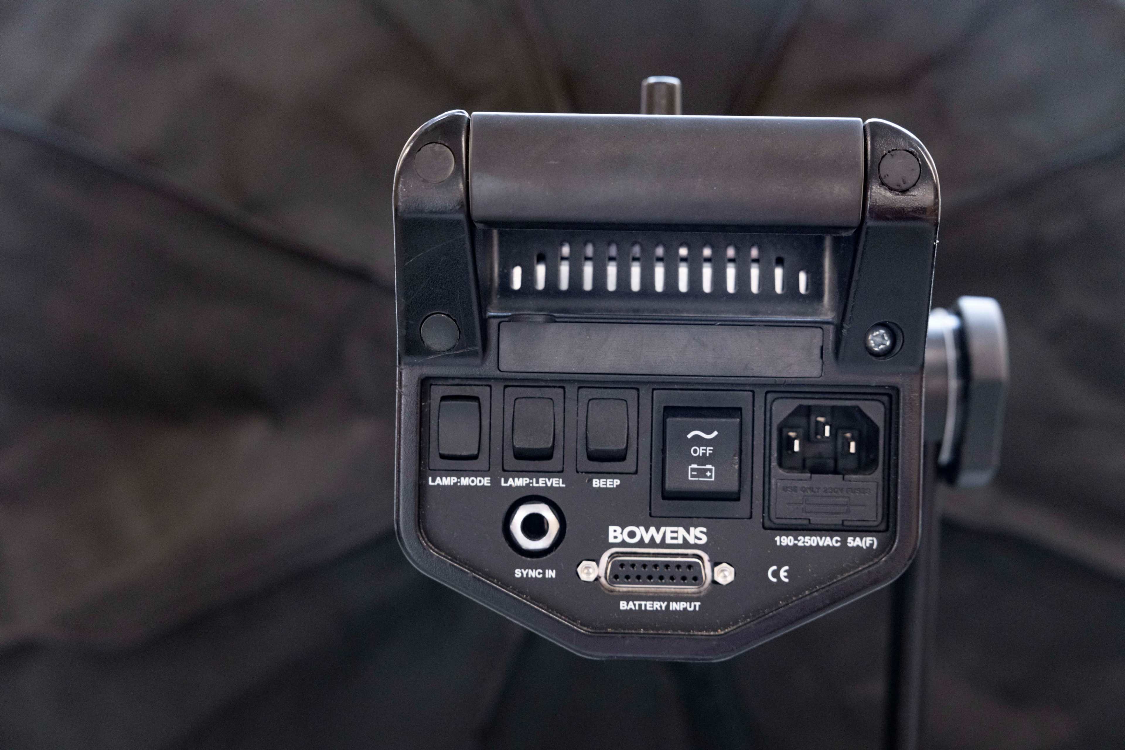 The image shows the back panel of a Bowens lighting unit, featuring various control buttons and input ports.