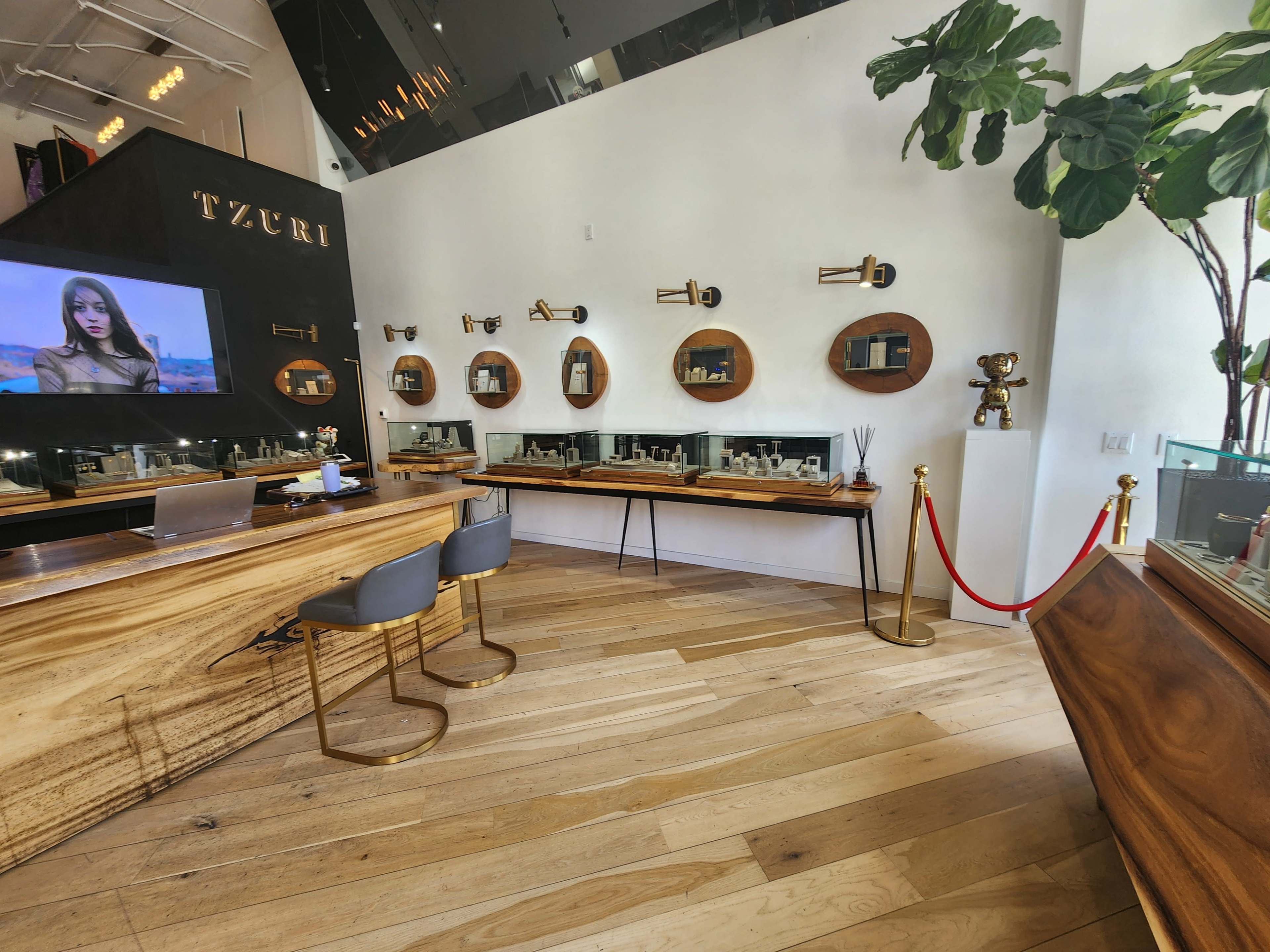 The image shows a modern skincare store with wooden display shelves, a reception area featuring a large screen, and potted plants.