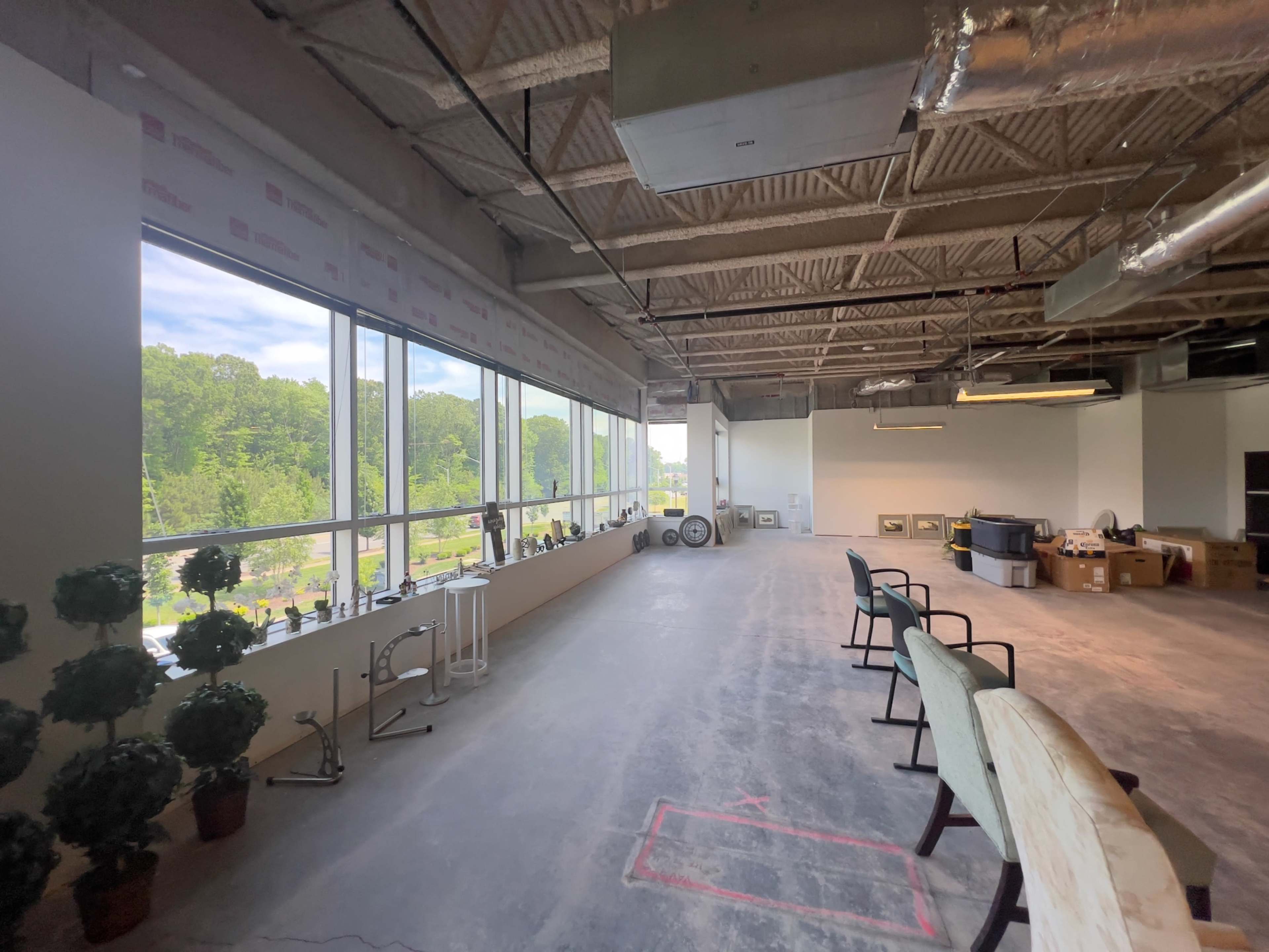 Industrial Studio space, white walls, concrete floors, high ceilings. Image in Central Newport News, Newport News, VA