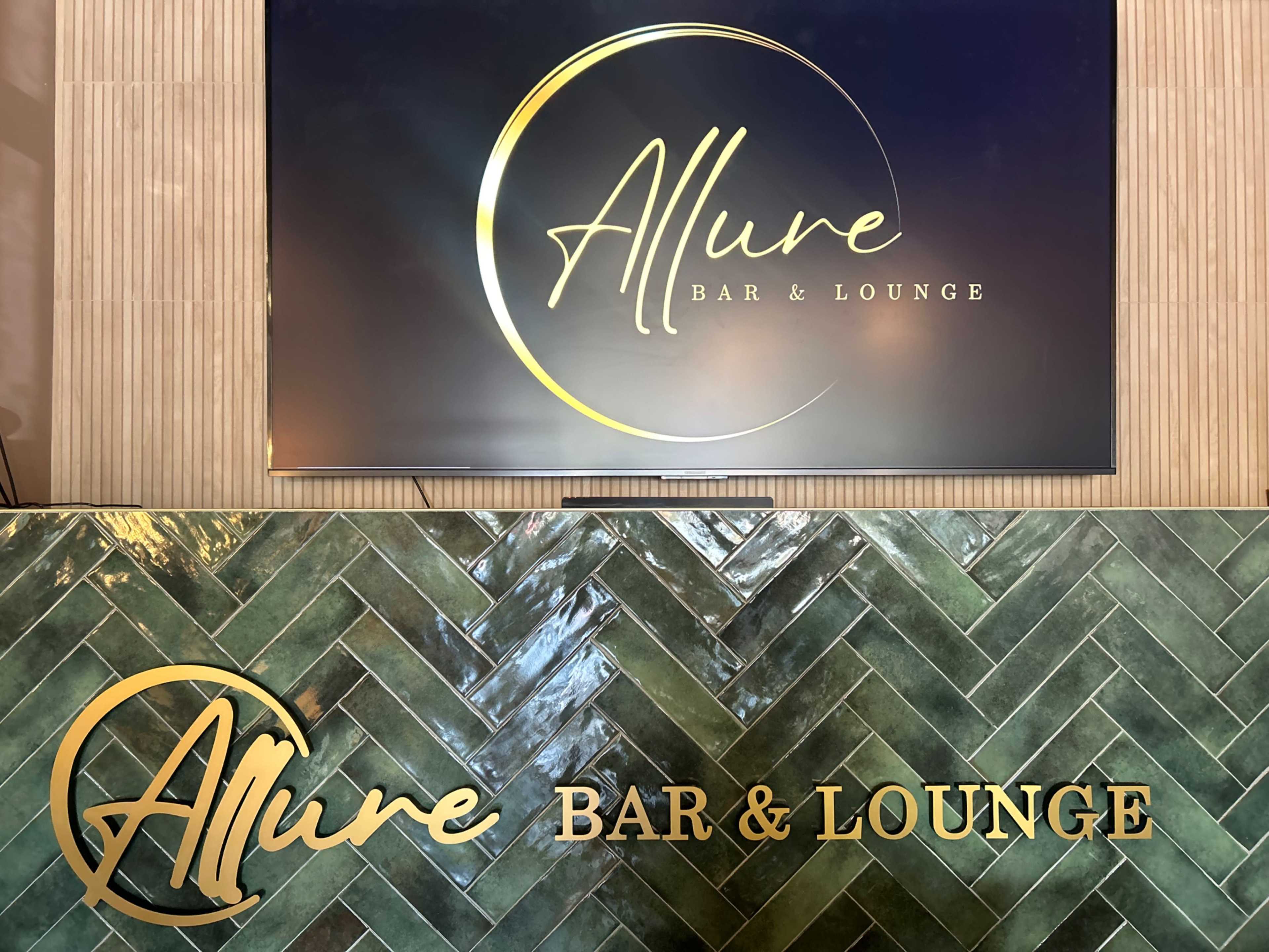 The image features a sign displaying the name "Allure Bar & Lounge" in elegant lettering, with a gold circular accent.