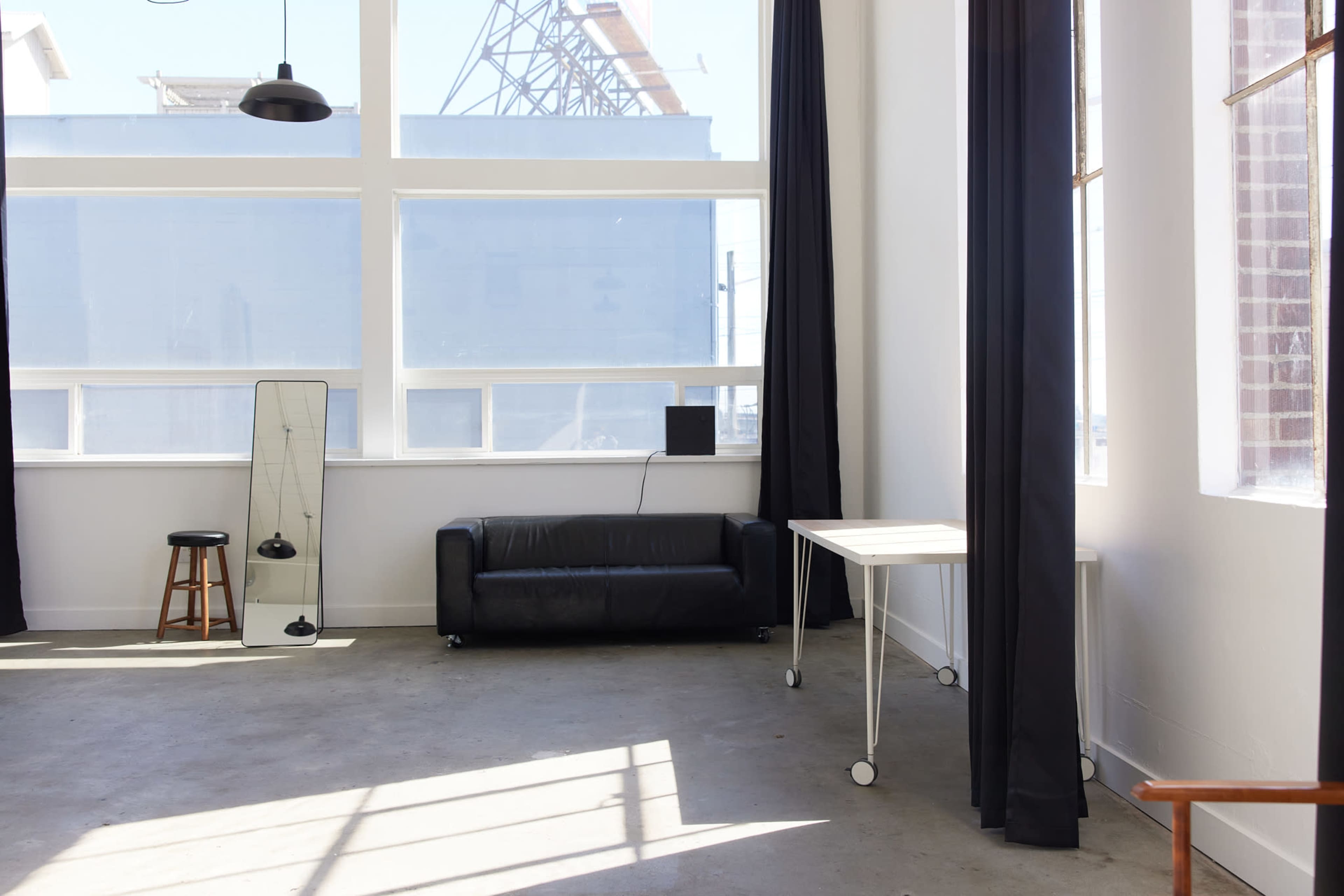 Clean White Studio with Concrete Floors & Natural Light Image in SODO, Seattle, WA