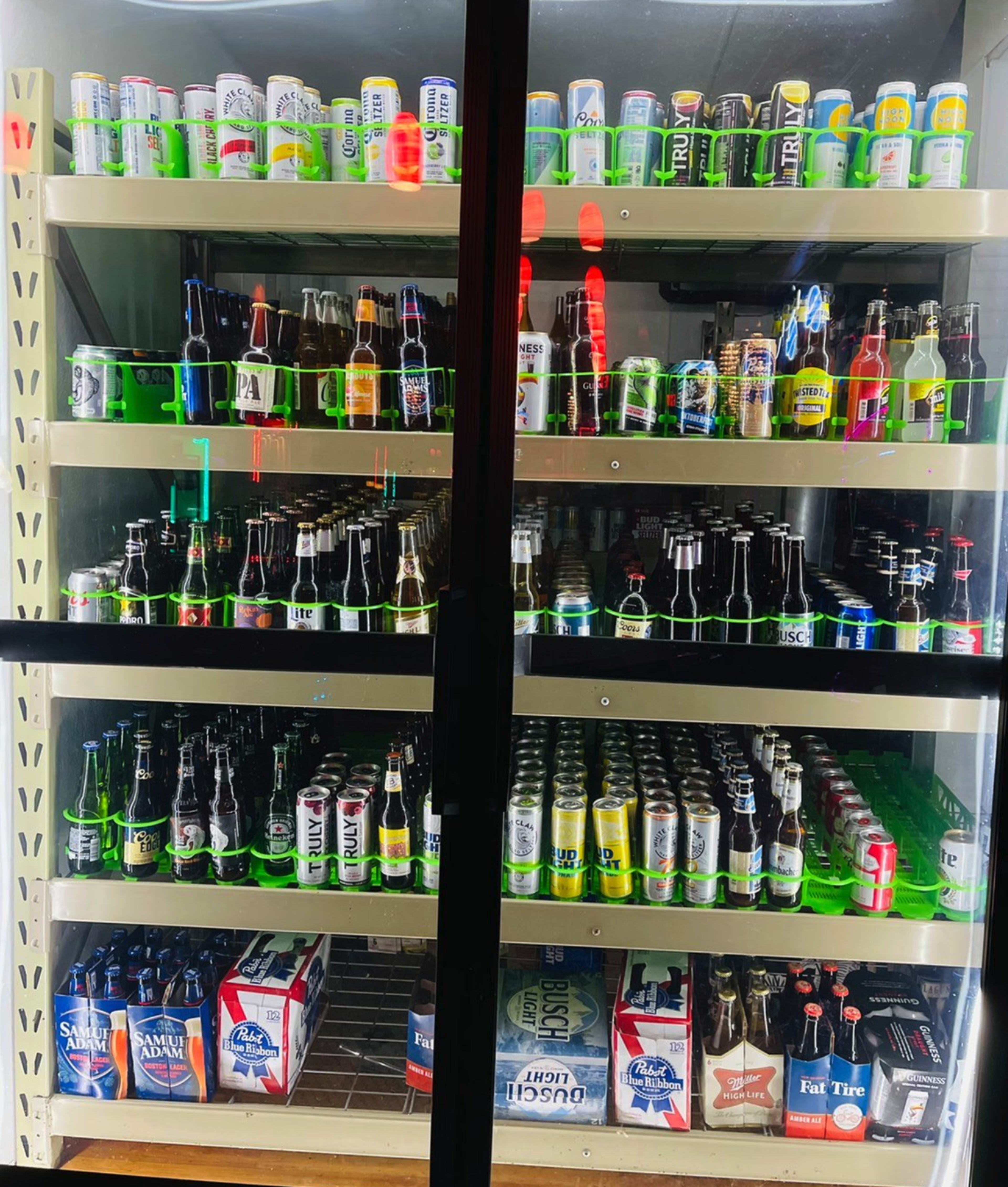 A vending machine displays a variety of canned and bottled beverages on multiple shelves.