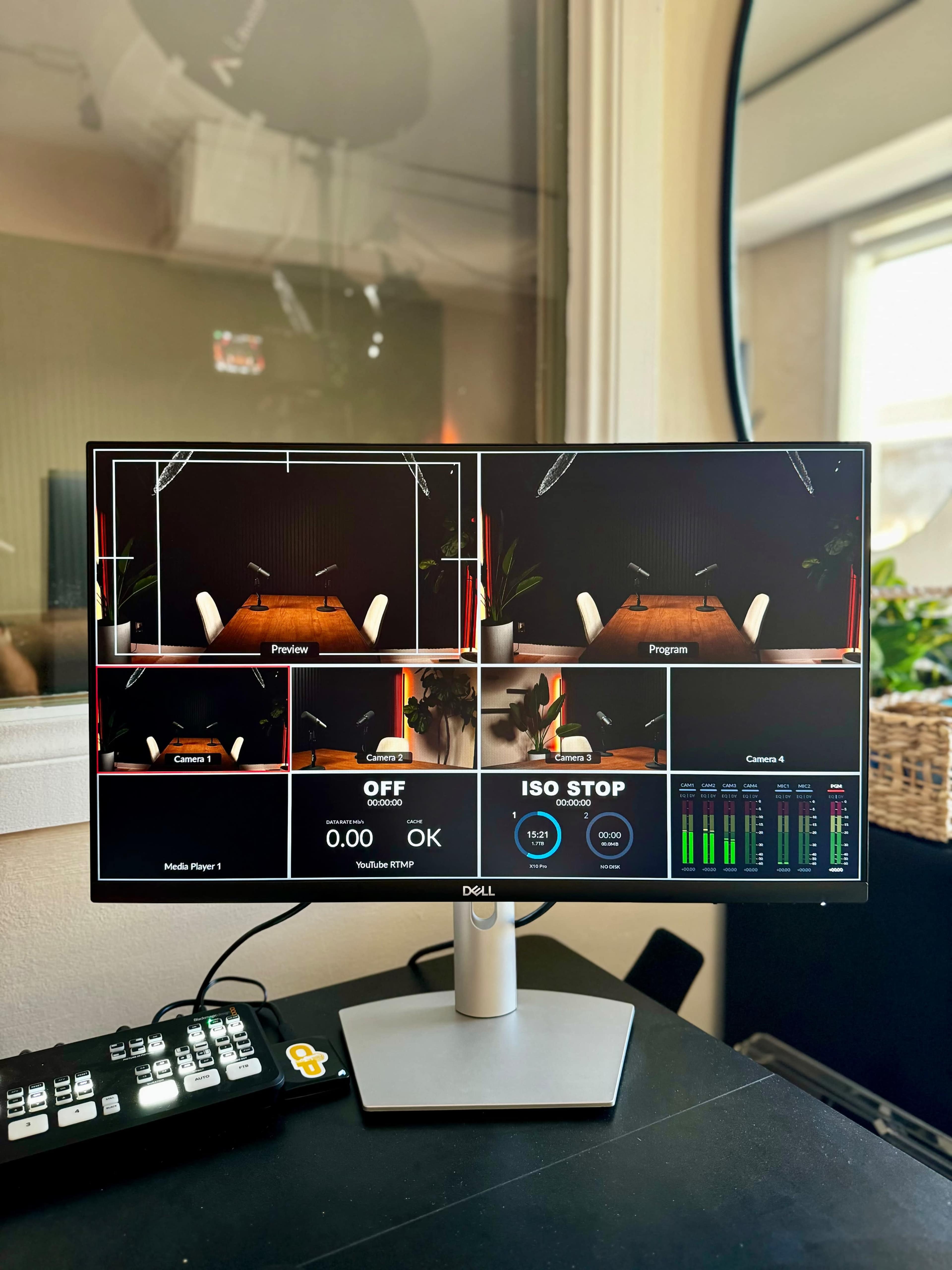 A computer monitor displaying multiple video feeds, with a control panel and various settings visible beneath it.