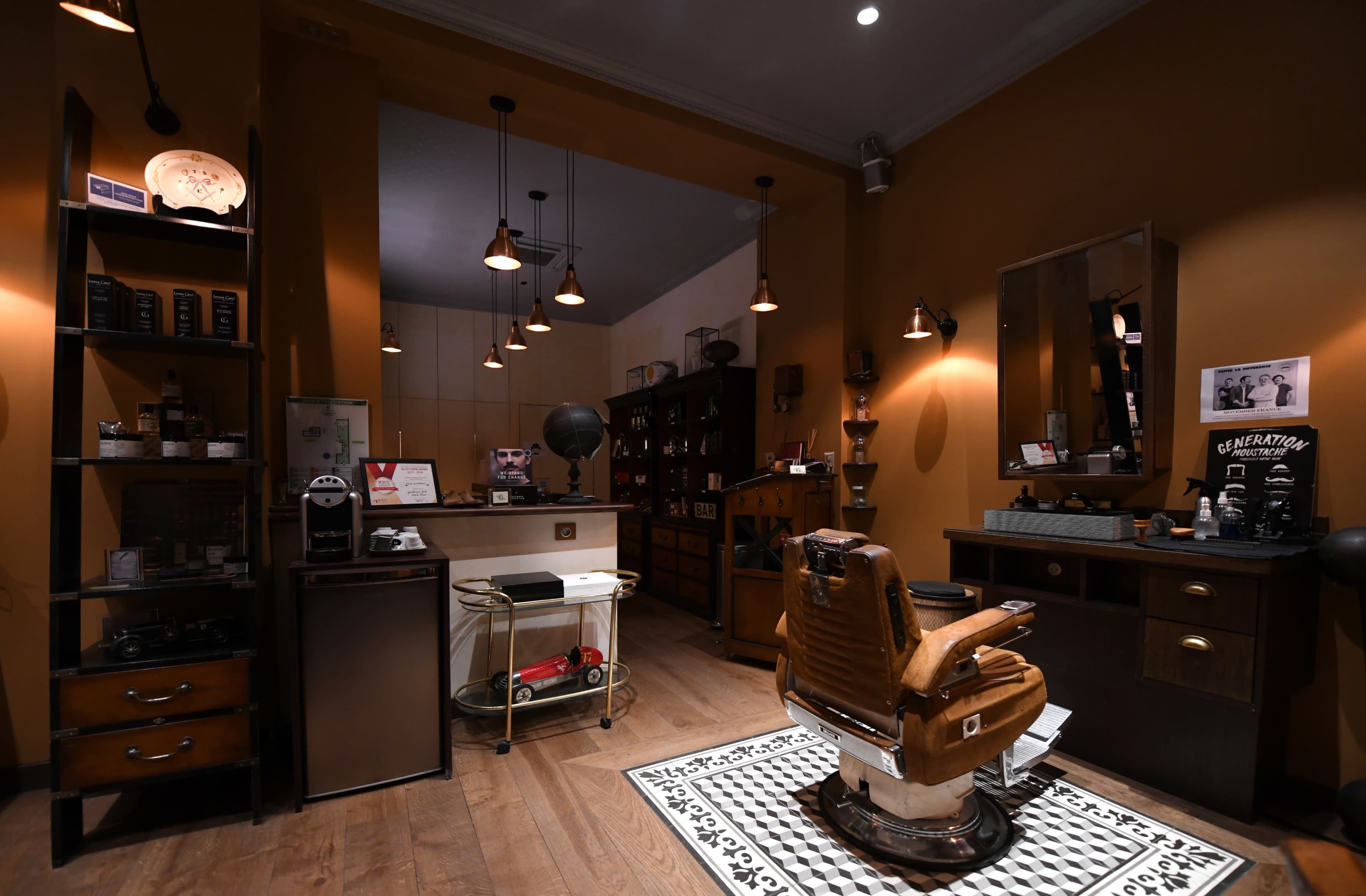 A stylish barber shop interior with a vintage barber chair, wooden shelves displaying grooming products, and warm lighting.