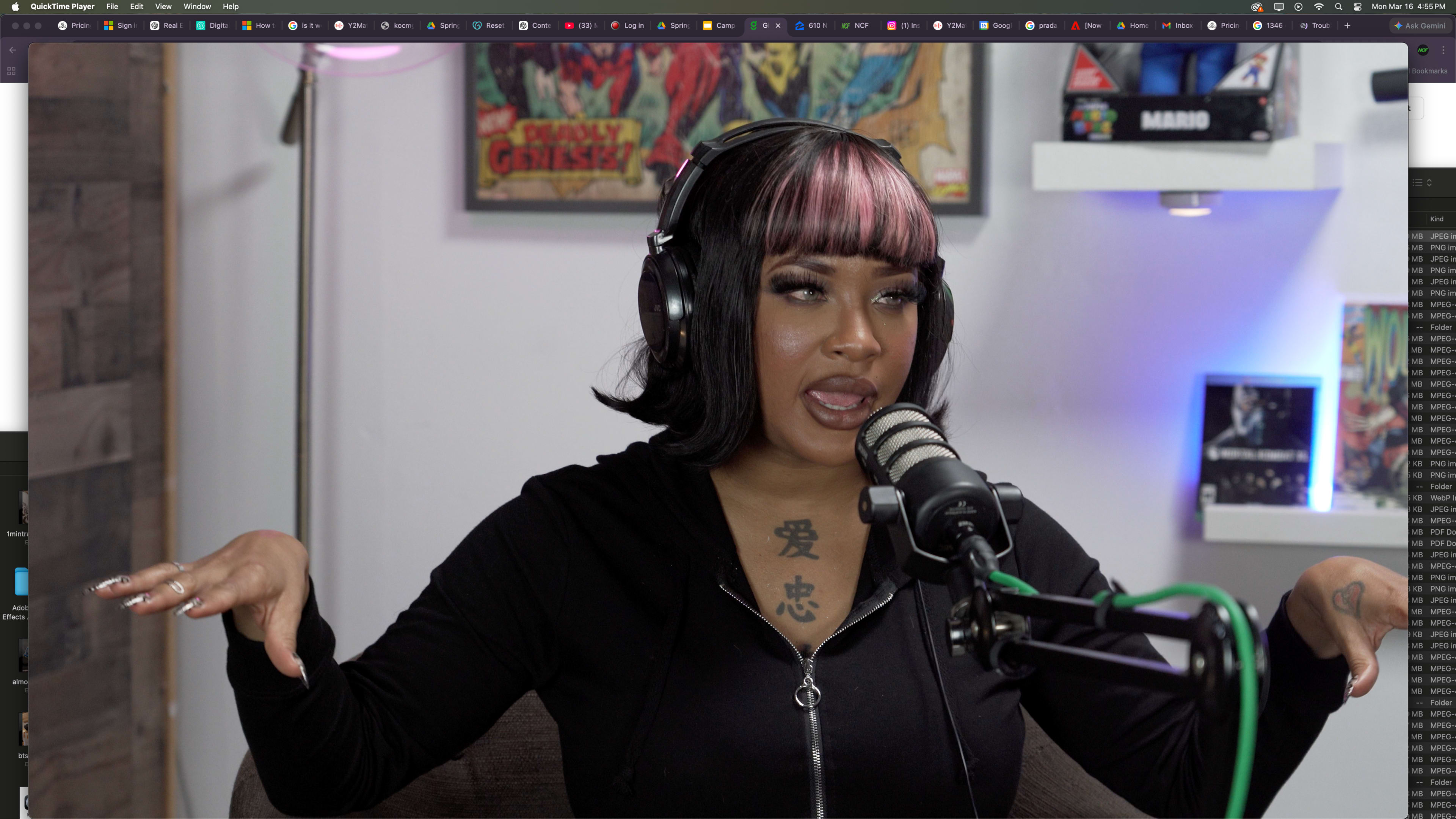A woman with black and pink hair is speaking into a microphone while wearing headphones.
