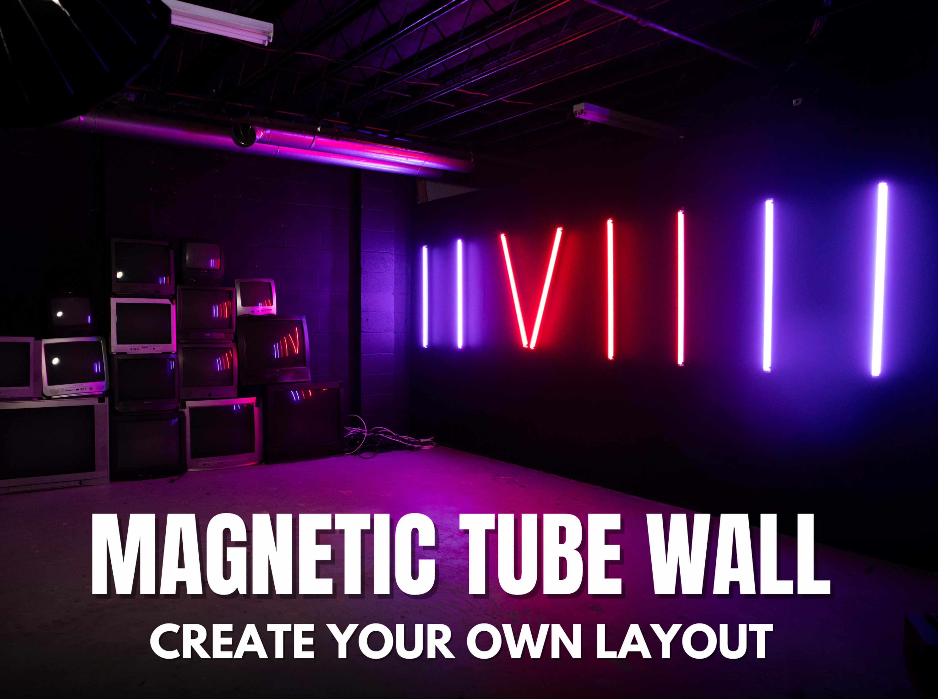 The image features a dark room with a magnetic tube wall displaying pink and blue neon lights, alongside a stack of old televisions in the background.