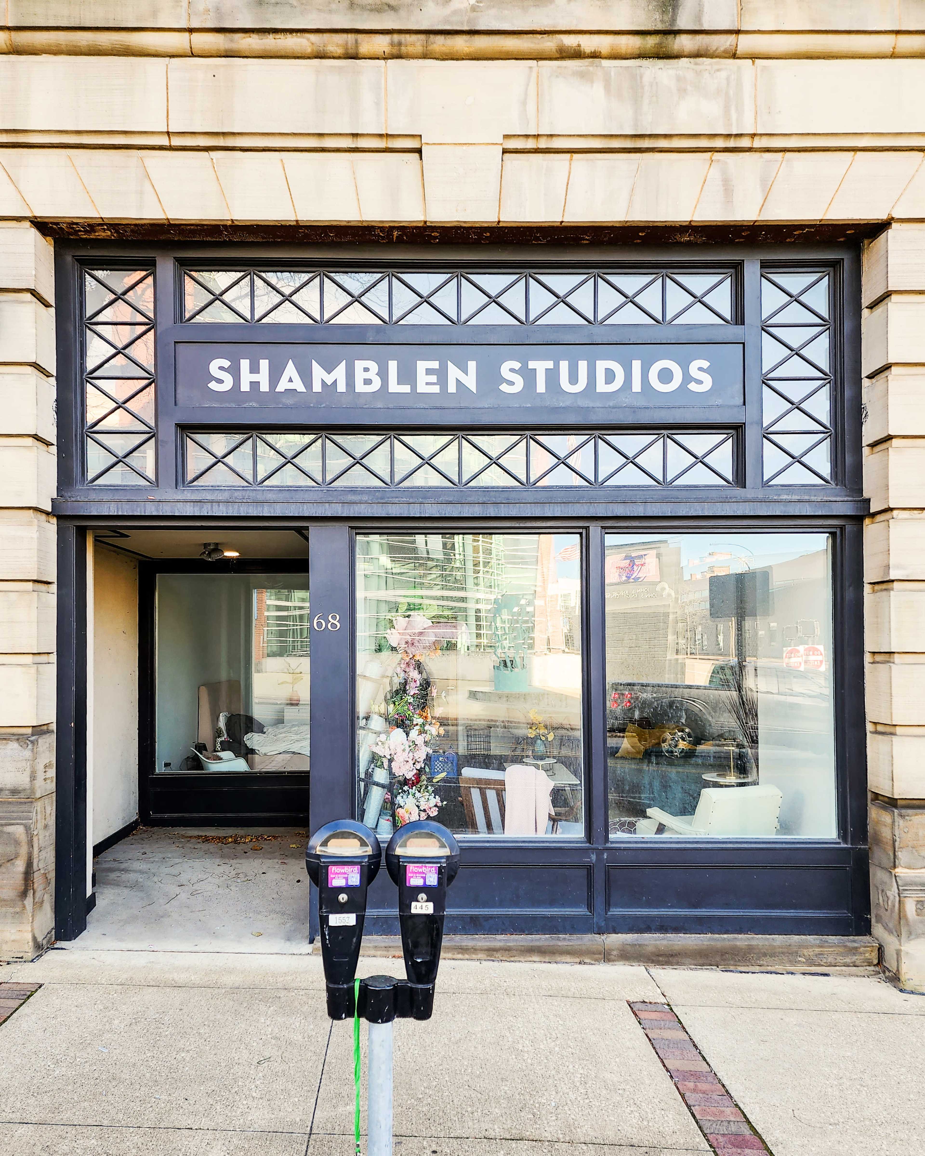 The storefront of Shamble Studios features large glass windows and a visible interior with furnishings, located at 68.