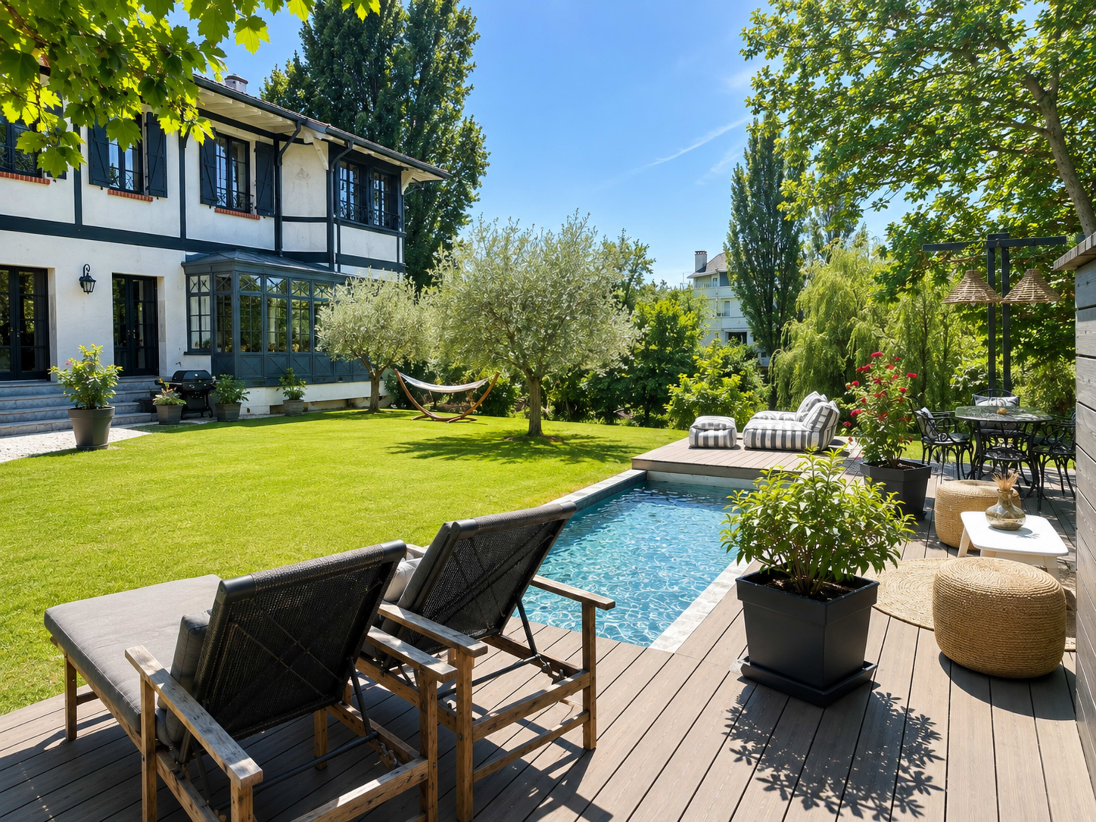 The image shows a well-maintained backyard featuring a swimming pool, lounge chairs, and a hammock, surrounded by greenery and a two-story house.
