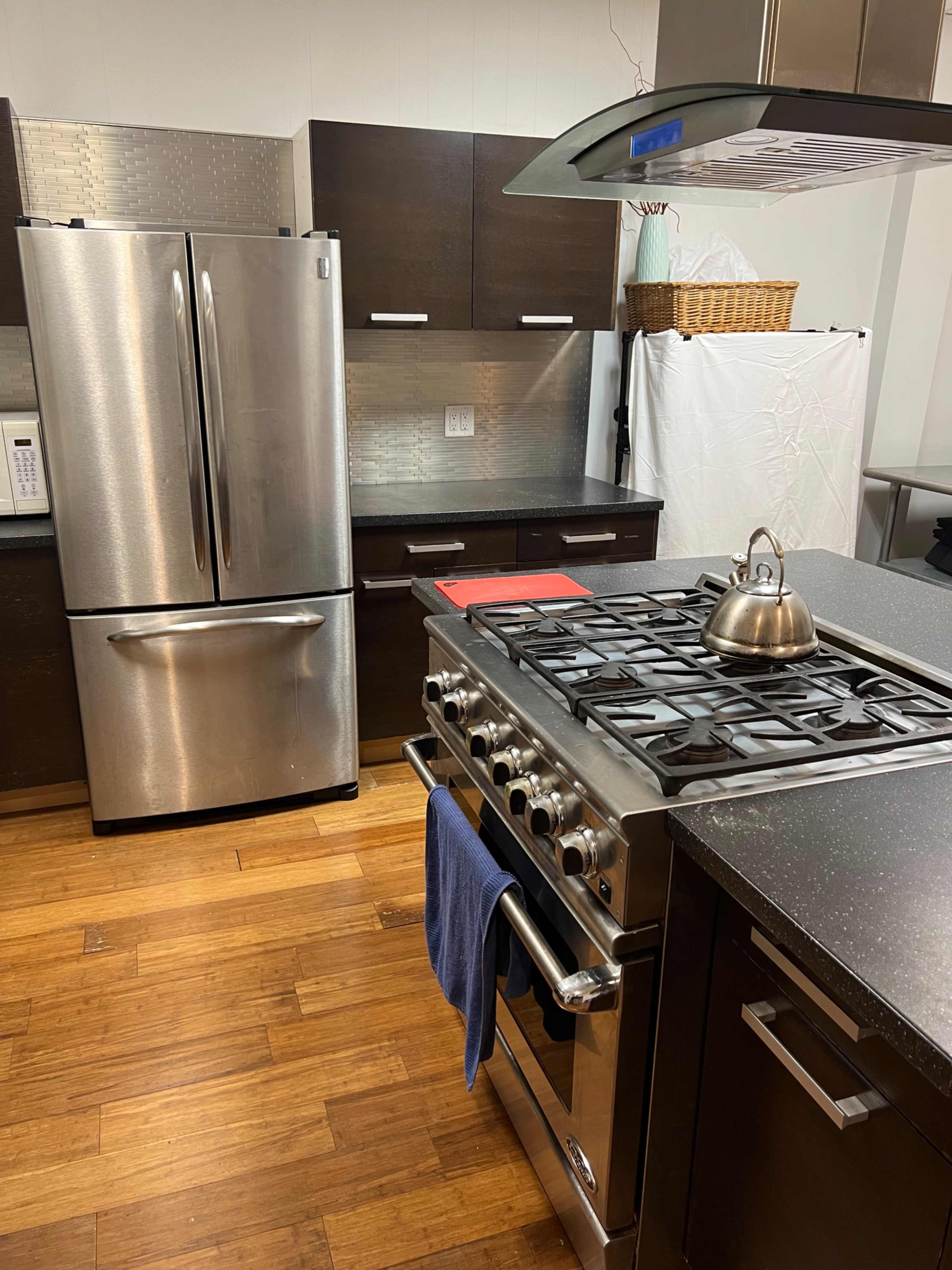 Large open room with gallery lighting and adjacent full kitchen. Image in Windsor Terrace, Brooklyn, NY